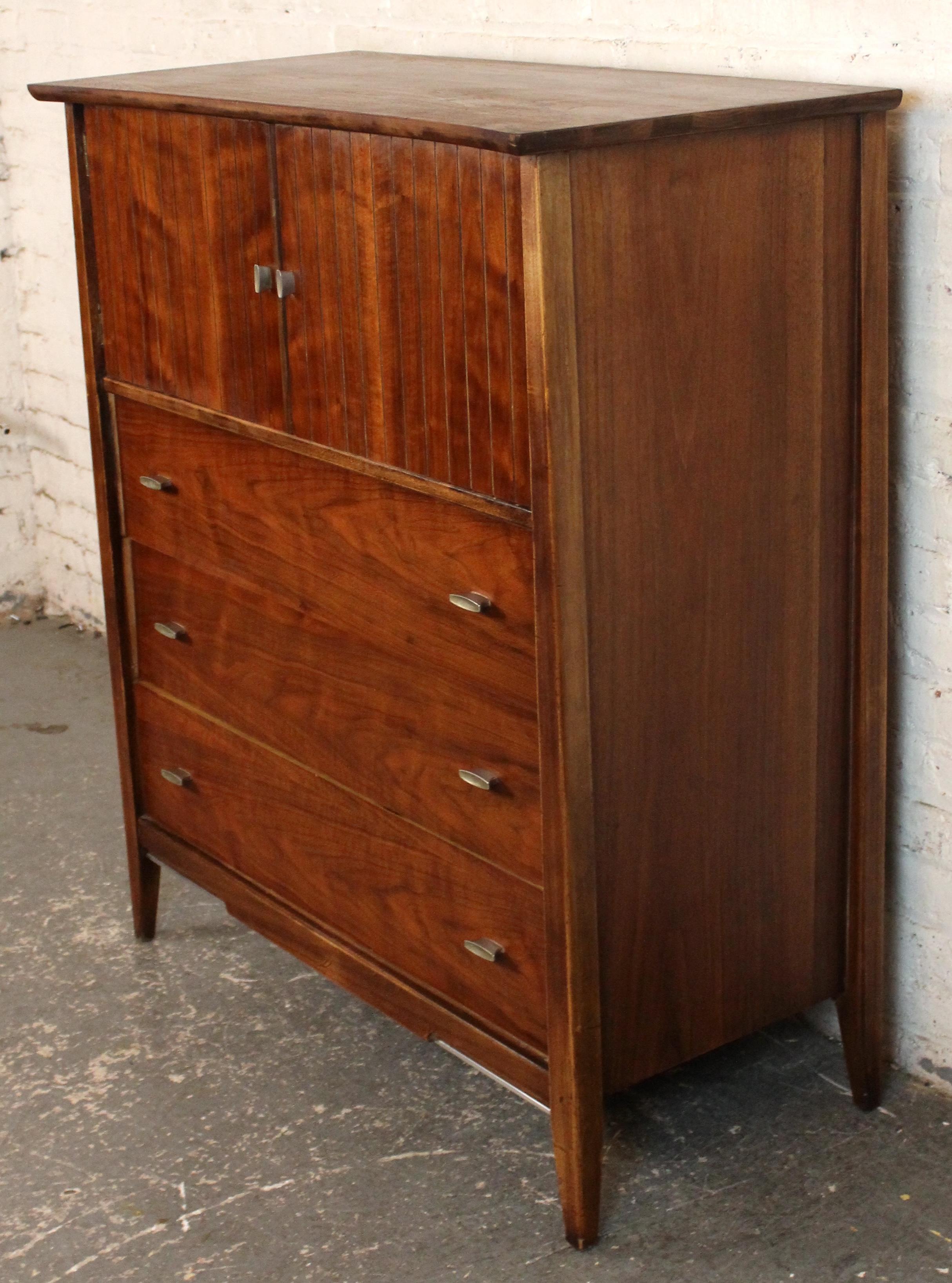 Diese elegante Mid-Century-Kommode aus Walnussholz von Harmony House zeichnet sich durch klare Linien, geschwungene Schubladengriffe und eine reiche Walnussoberfläche aus, die die natürliche Maserung hervorhebt. Drei geräumige Schubladen und zwei