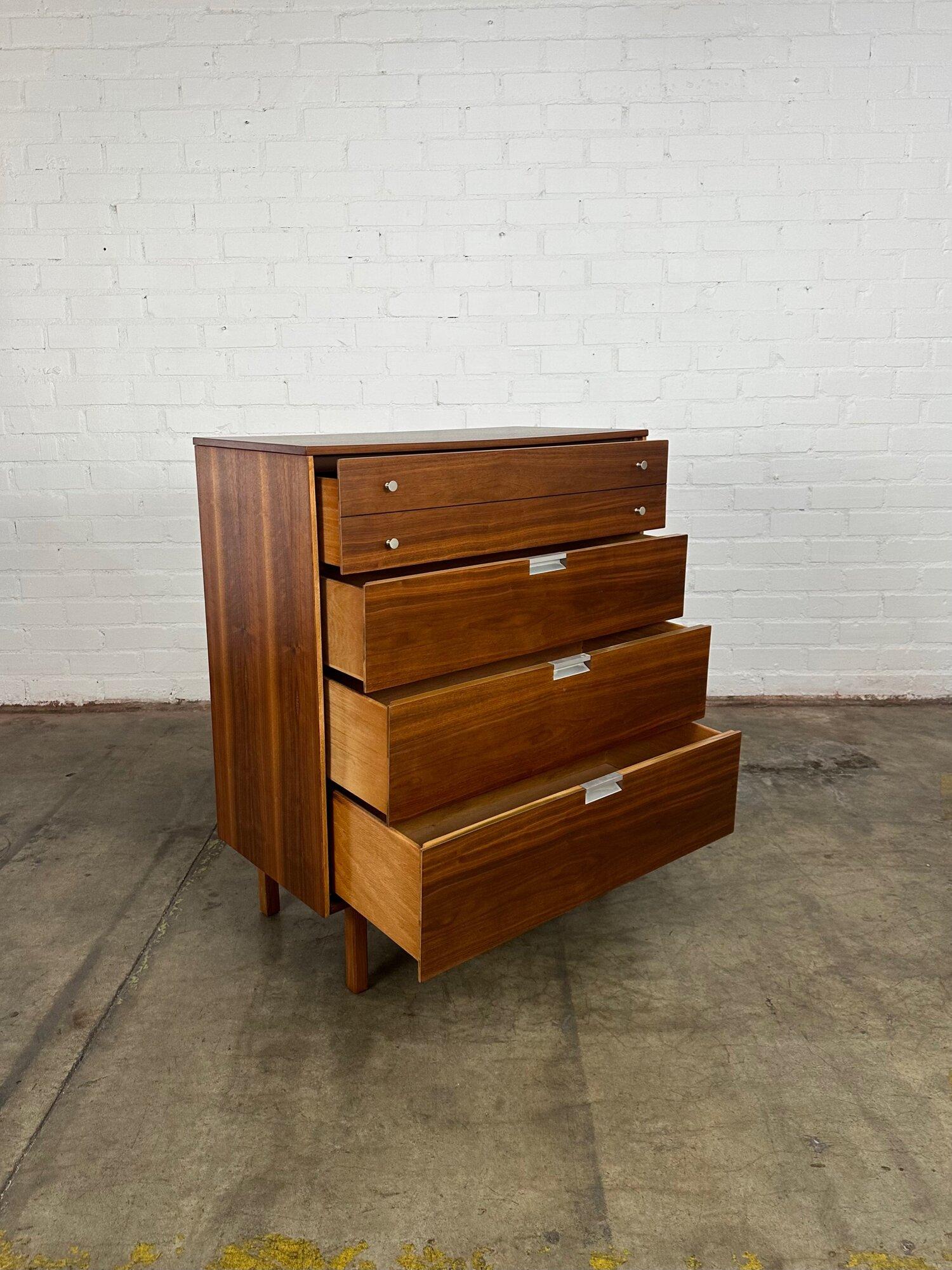 Dimensions: W36 D18 H43

Vintage highboy with chrome original hardware with four smooth sliding drawers with solid wood drawers, walnut veneer on the exterior with angled legs and deep drawers. Great restored condition with minor sign of wear.