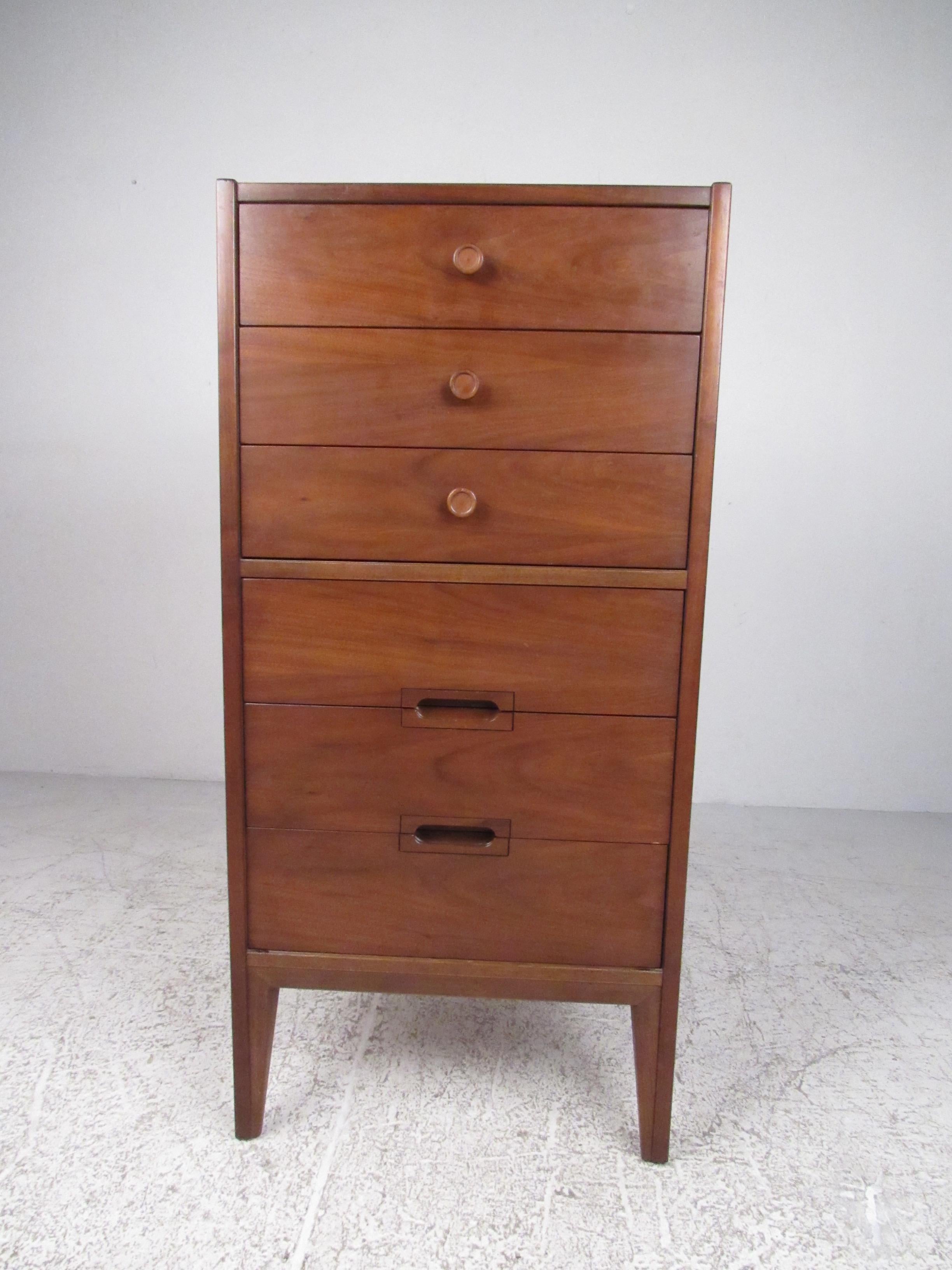 Narrow and tall, this six-drawer walnut dresser is both functional and an attractive Mid-Century Modern furnishing. Please confirm item location (NY or NJ) with dealer.