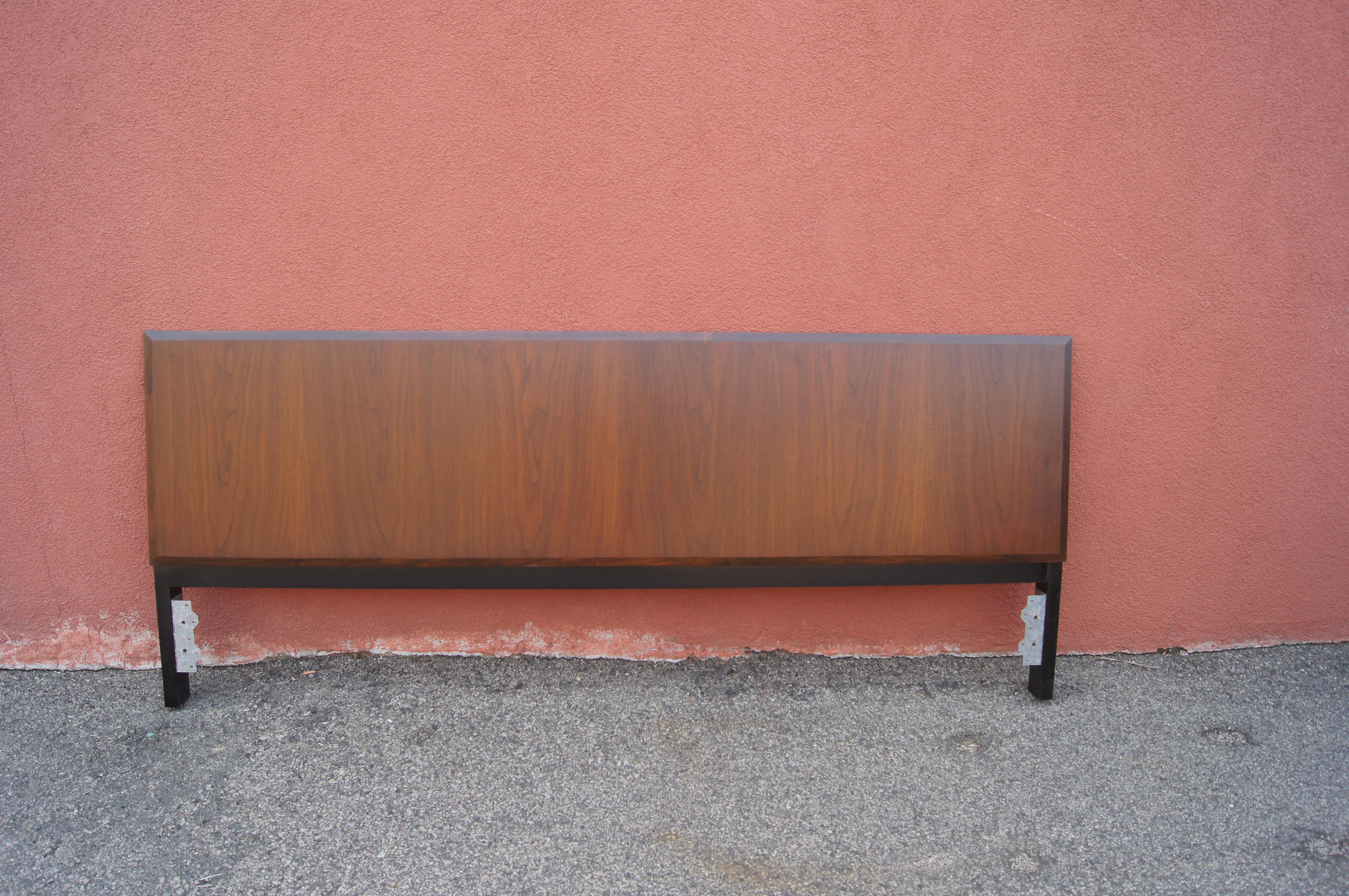 Milo Baughman designed by this mid-century headboard for the Directional Furniture Company. Crafted of .75 inch-thick walnut, attached to sturdy ebonized legs, it fits a king-size bed.

Note that the dimensions below include the depth of the