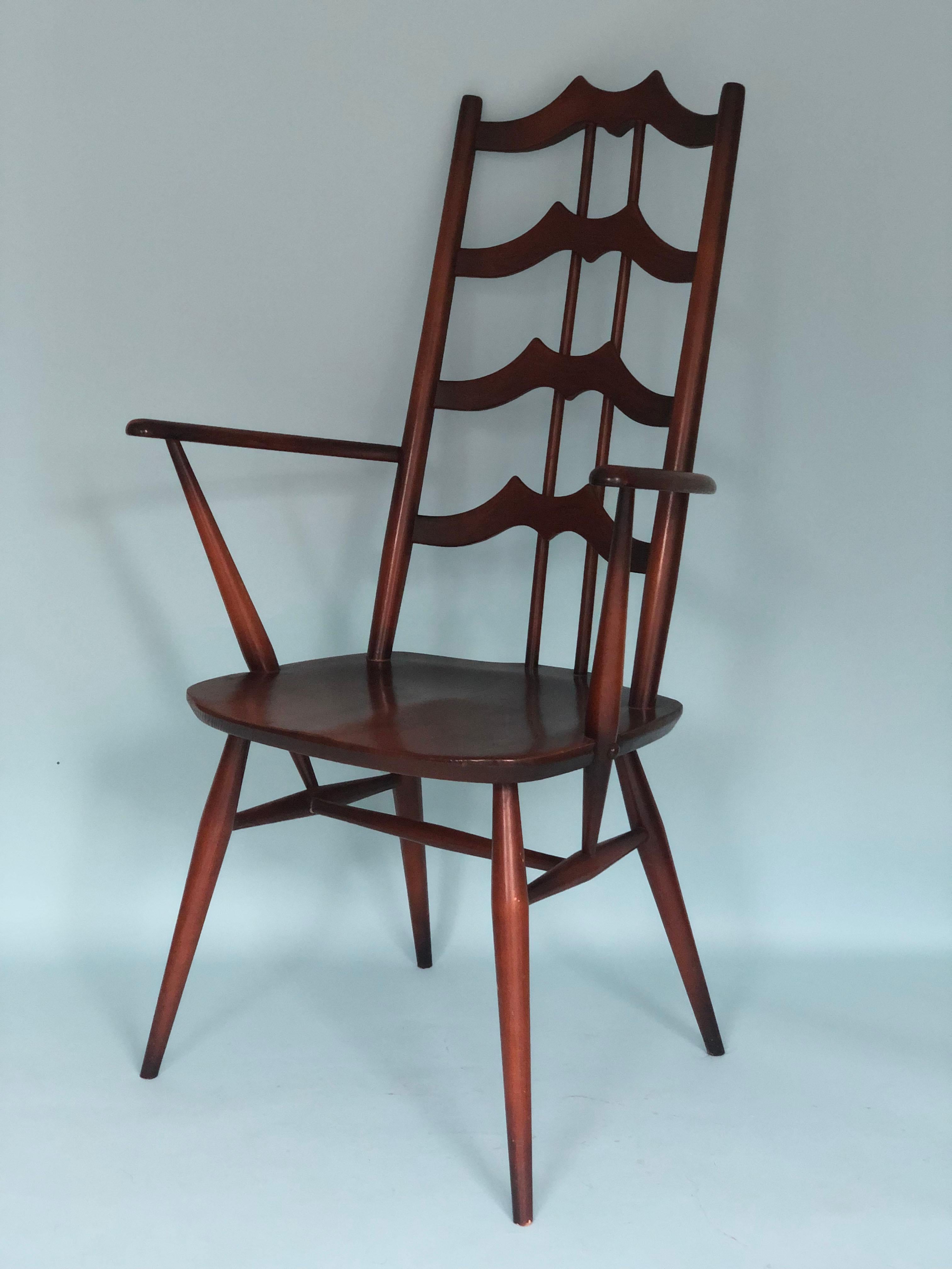 A pair high back mid century dining room chairs designed by Lucian Ercolani for Ercol. The 