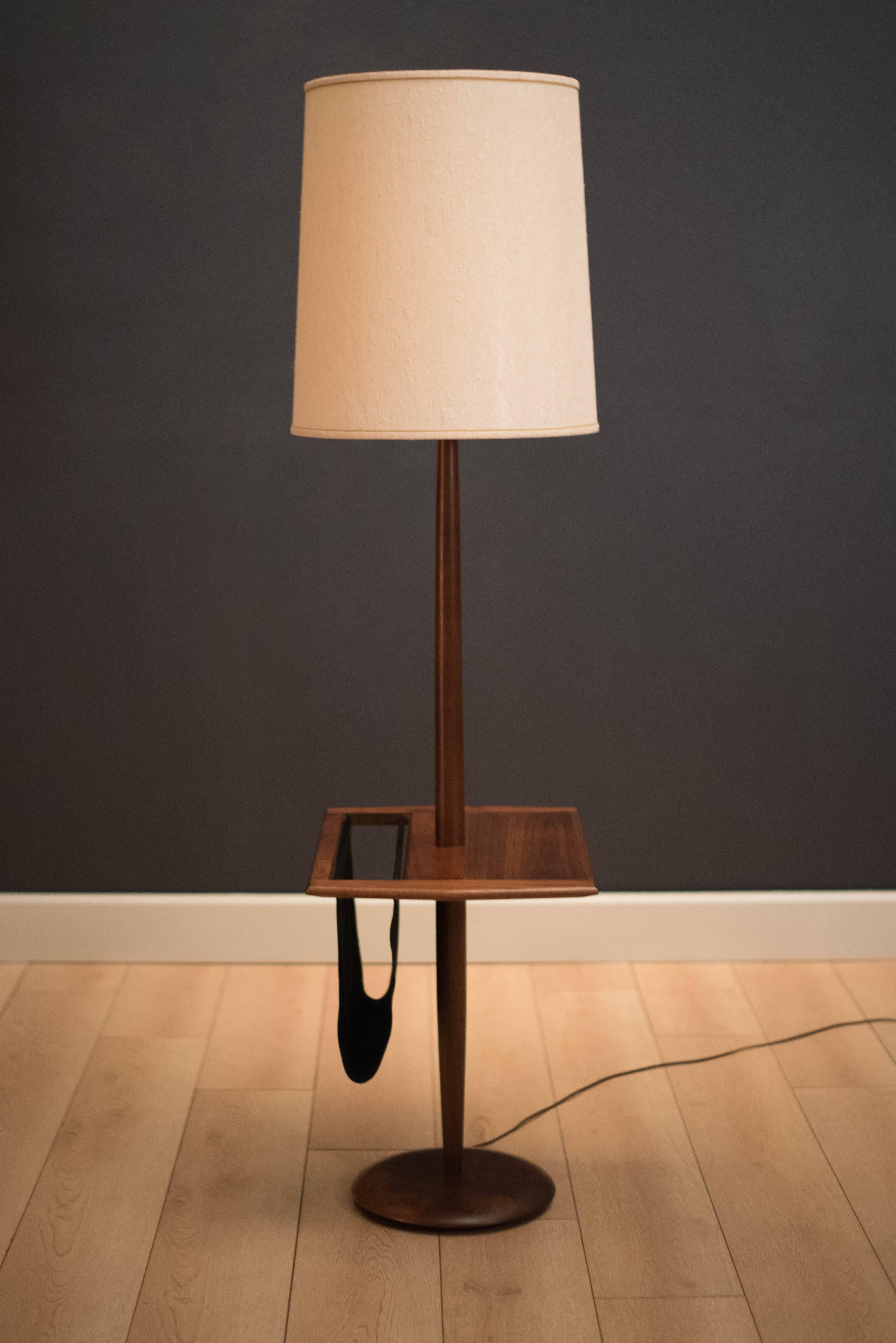 Vintage laurel floor lamp in walnut with built in side table. This functional piece includes a suede leather magazine holder attached. Lamp has a three way switch mechanism. Shade is not included.