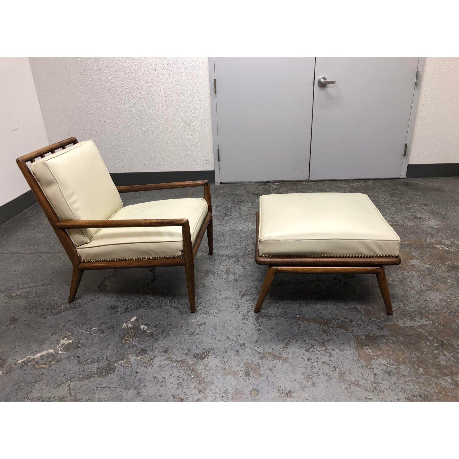 A midcentury chair and ottoman. Originally purchased from an antique showroom. The frame is crafted from solid woods in a walnut finish. Upholstered in an ivory leather. Minor condition on ottoman corner and towards bottom of seat. The back cushions