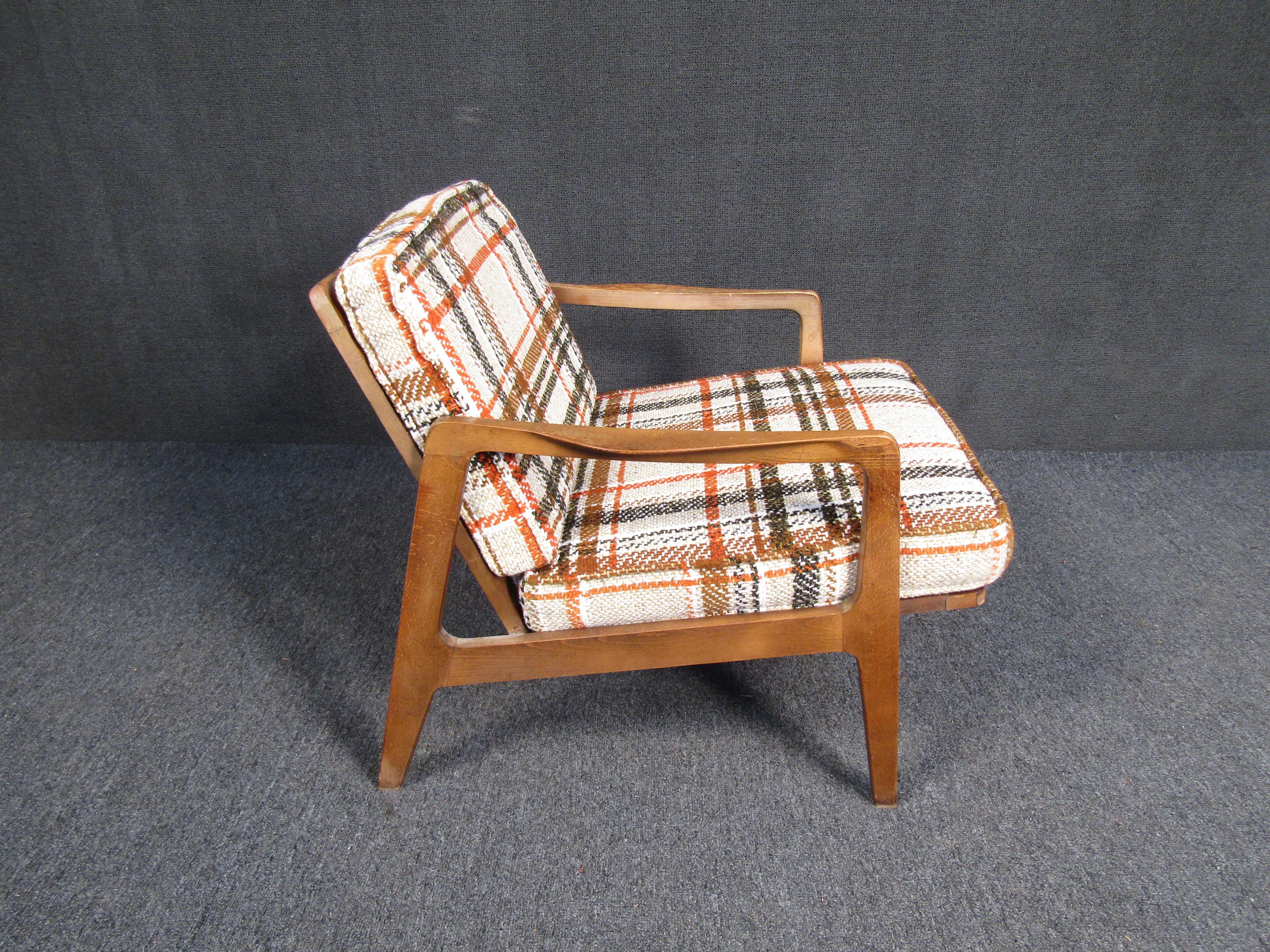 A stylish and colorfully-upholstered walnut lounge chair with comfortable large cushions. Please confirm item location with seller (NY/NJ).