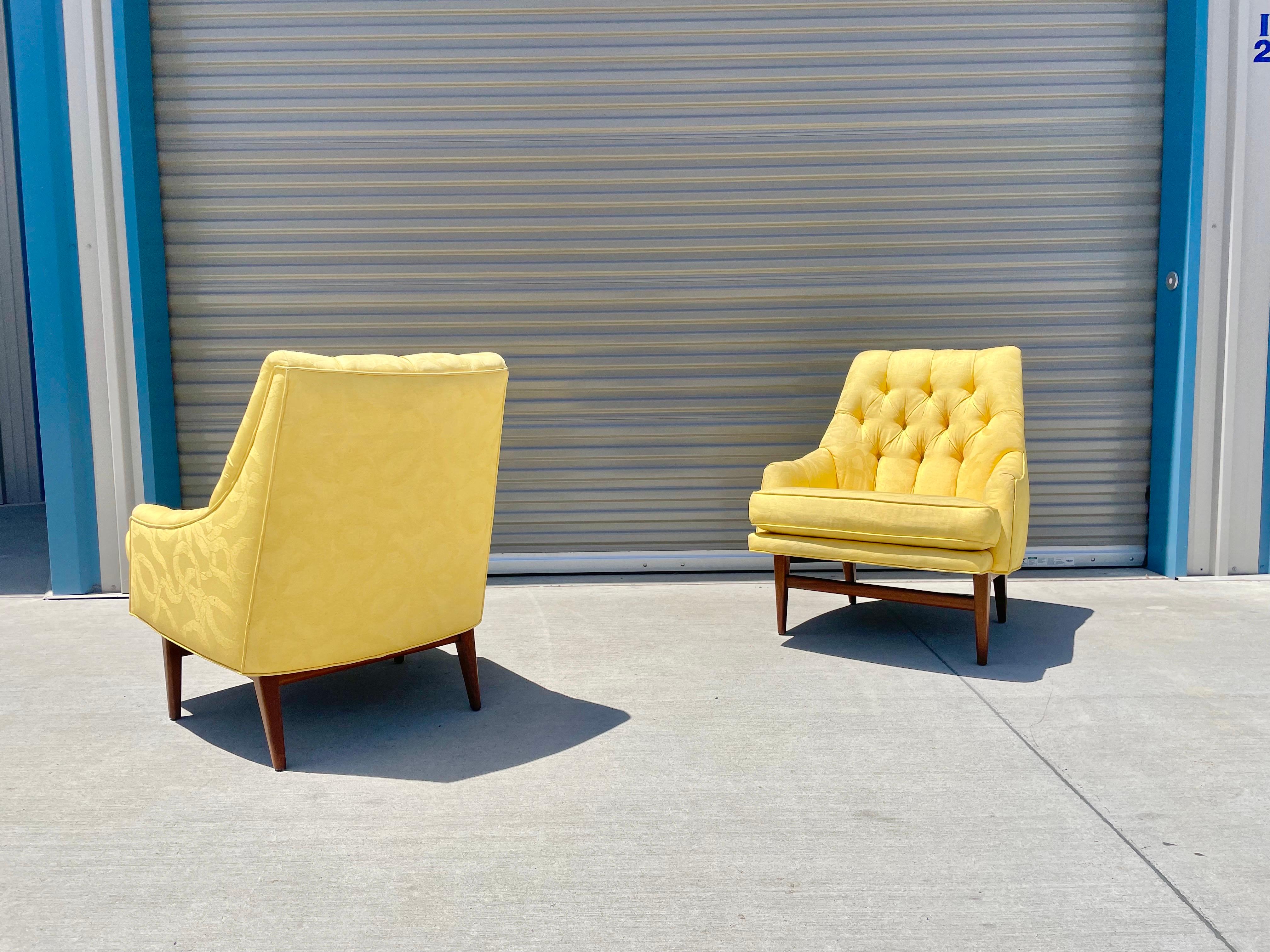 Midcentury walnut lounge chairs attributed to Monteverdi Young These vintage lounge chairs feature a yellow tufted upholstery with a sculptural solid walnut base. The chairs can be used as-is, or you have the power to have them redone in any way you