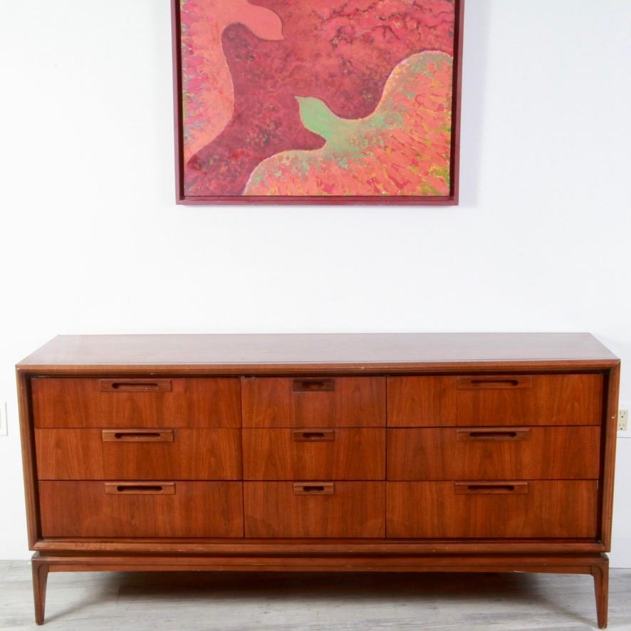 Classic MCM 70s era 9-drawer dresser from Uniter Furniture. Dovetailed construction that is in clean overall condition with a scuff mark or two on front edges. Drawers slide smoothly on their tracks.