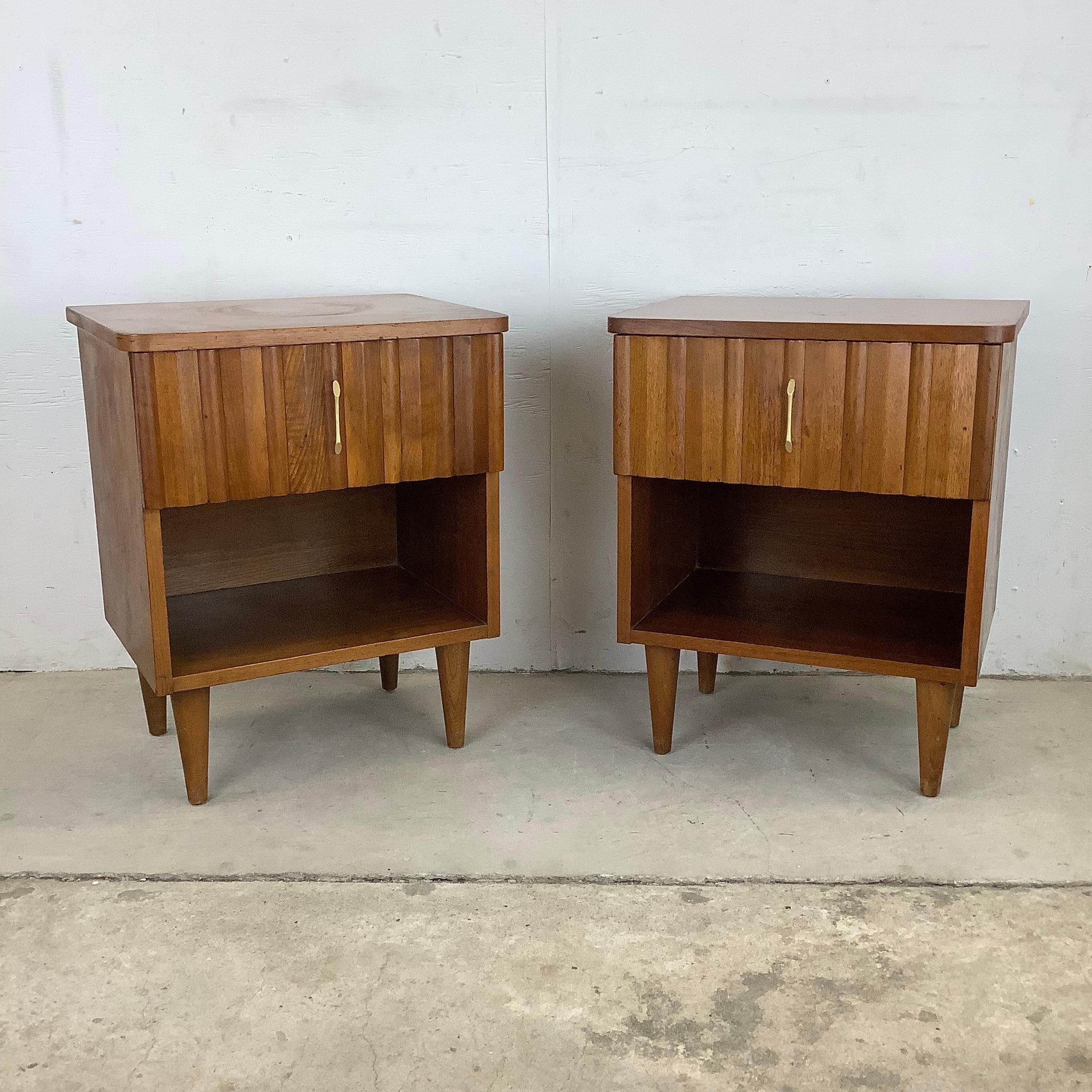 This vintage pair of midcentury nightstands feature a striking mix of upper drawer with lower shelf storage making for a versatile set of end tables for bedside storage or as living room end tables. The unique wood finish and clean modern lines add