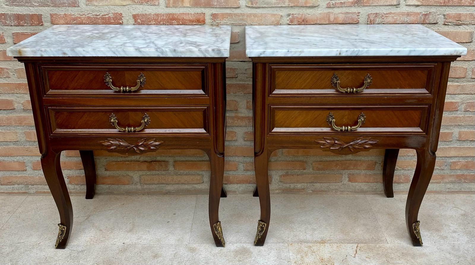 We are delighted to introduce this pair of French walnut nightstands.
The front drawers have this beautiful burr in the wood, with original handles to open all the drawers and white marble top.
Also, the legs are very well carved and shaped.

We