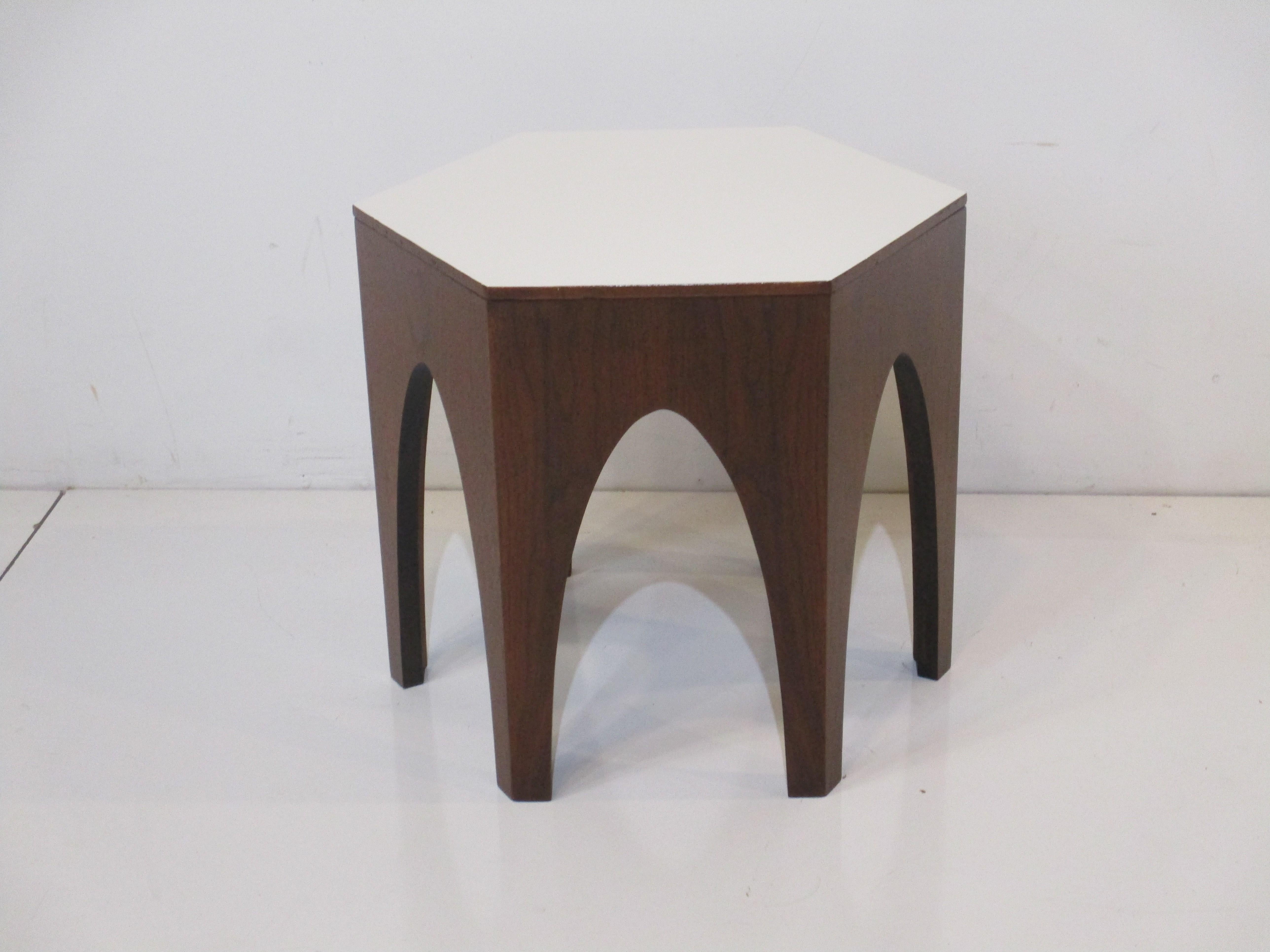 A nice sized walnut octagon side / end table with arched legs and a white laminate top. The perfect table next to that lounge chair or corner area that needs just a little something. Designed in the manner of Harvey Probber.