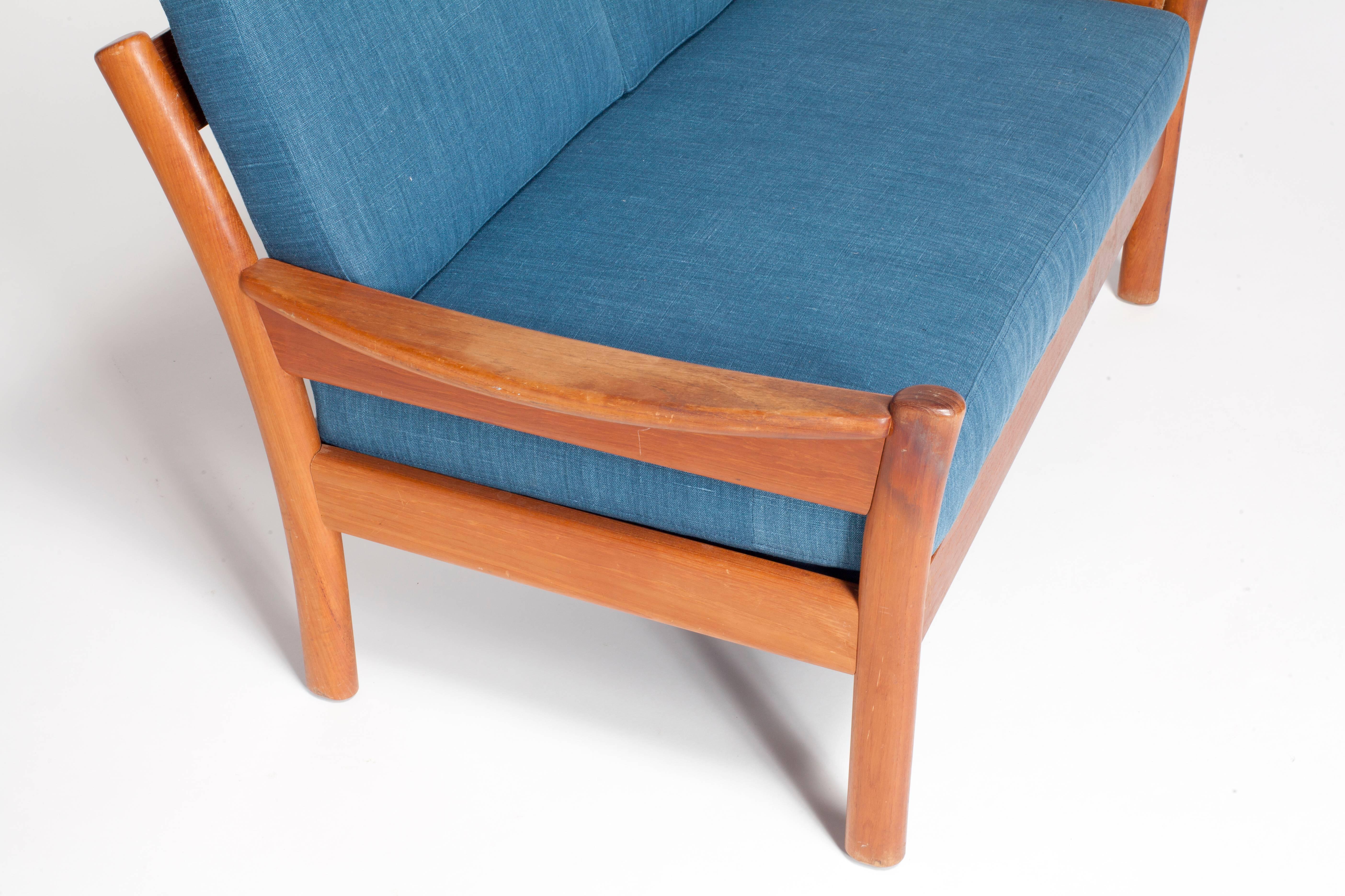 Midcentury walnut open framed settee upholstered in blue linen.