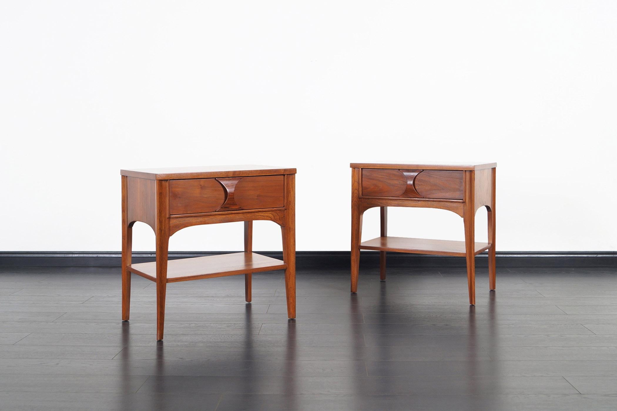 Midcentury walnut nightstands by Kent Coffey for the Perspecta series line. Each nightstand features a single dovetail drawer with a sculpted rosewood handle.