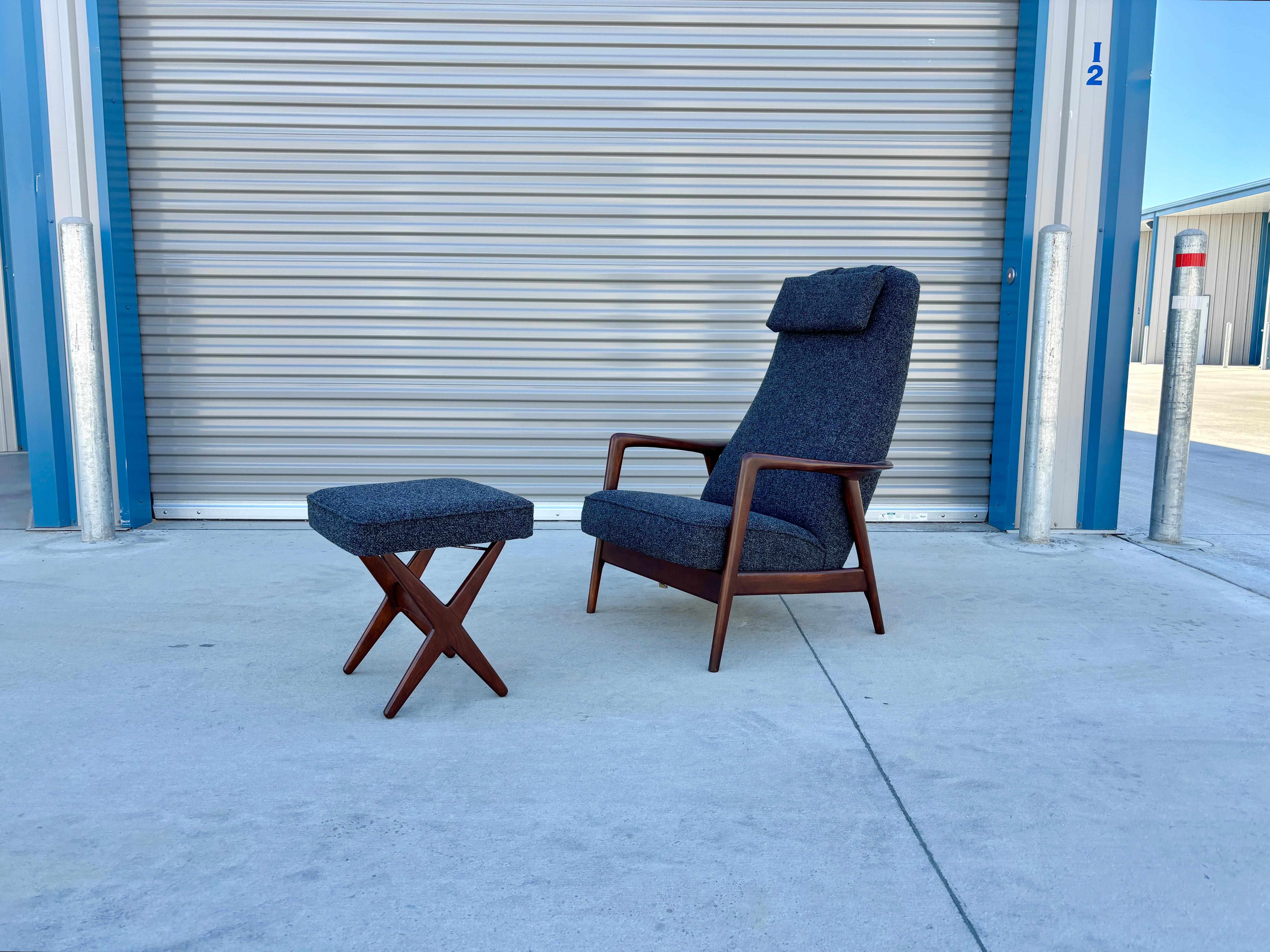 Mid-century walnut recliner lounge chair and ottoman designed by Alf Svensson and manufactured by Dux in Sweden circa 1950s. This set has been refinished and reupholstered. The chair's frame showcases exquisitely sculptured walnut armrests, adding