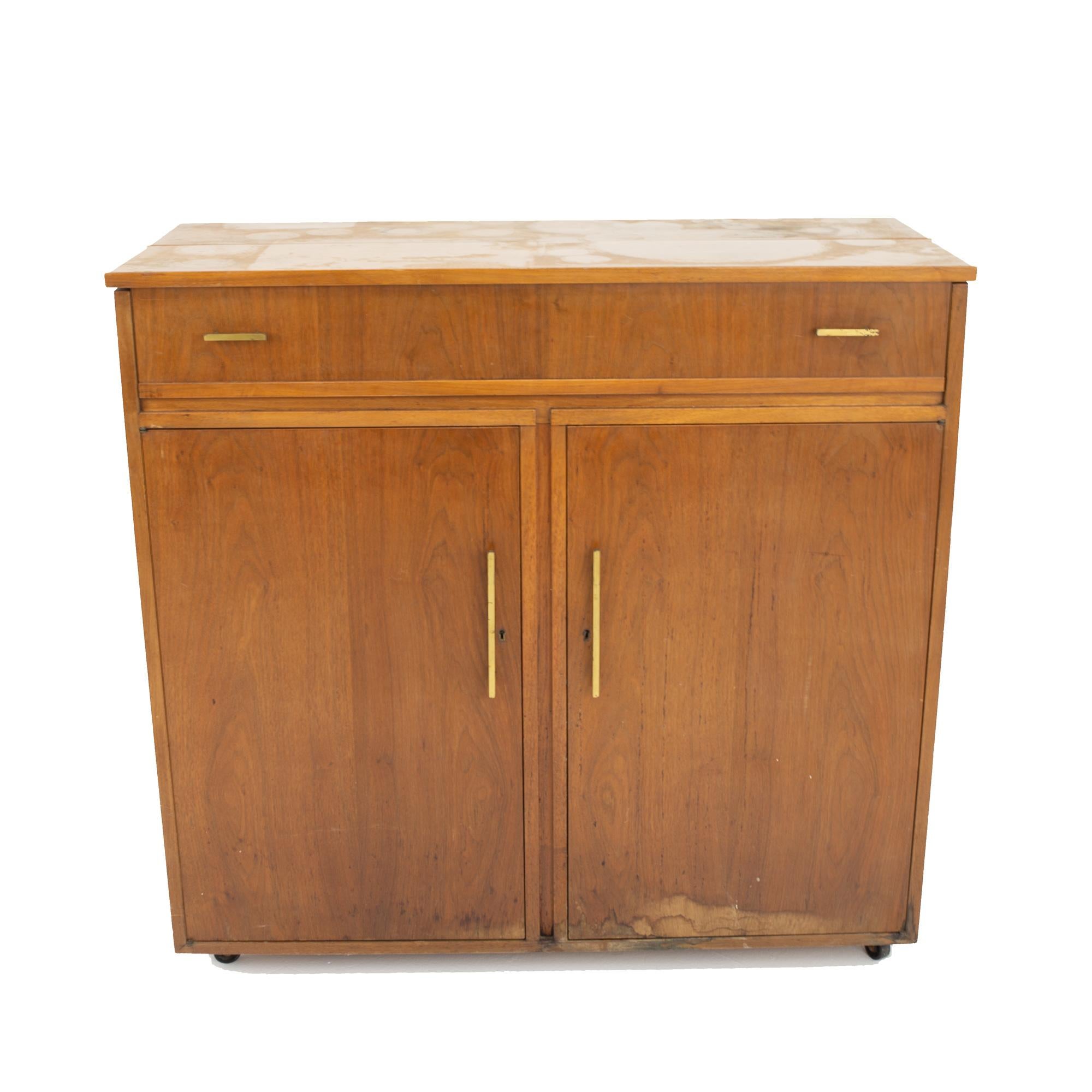 Mid Century walnut refrigerator bar
Cabinet measures: 42 wide x 18.5 deep x 40 high 

All pieces of furniture can be had in what we call restored vintage condition. This means the piece is restored upon purchase so it’s free of watermarks, chips or