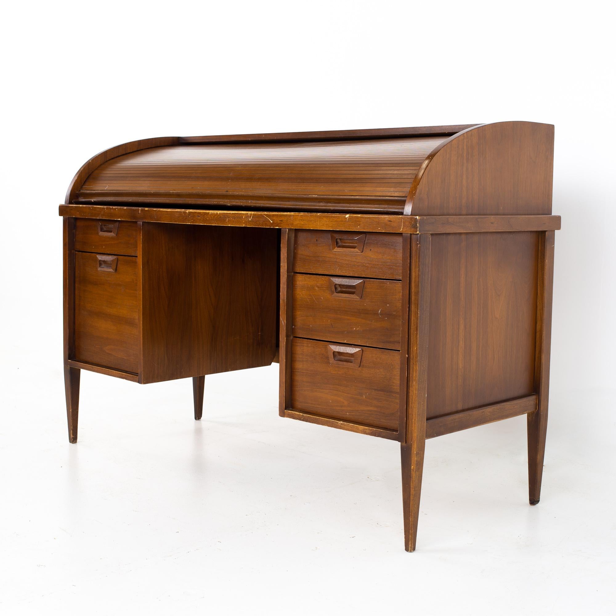Mid century walnut roll top desk
Desk measures: 55.25 wide x 22.75 deep x 38 inches high

All pieces of furniture can be had in what we call restored vintage condition. That means the piece is restored upon purchase so it’s free of watermarks,