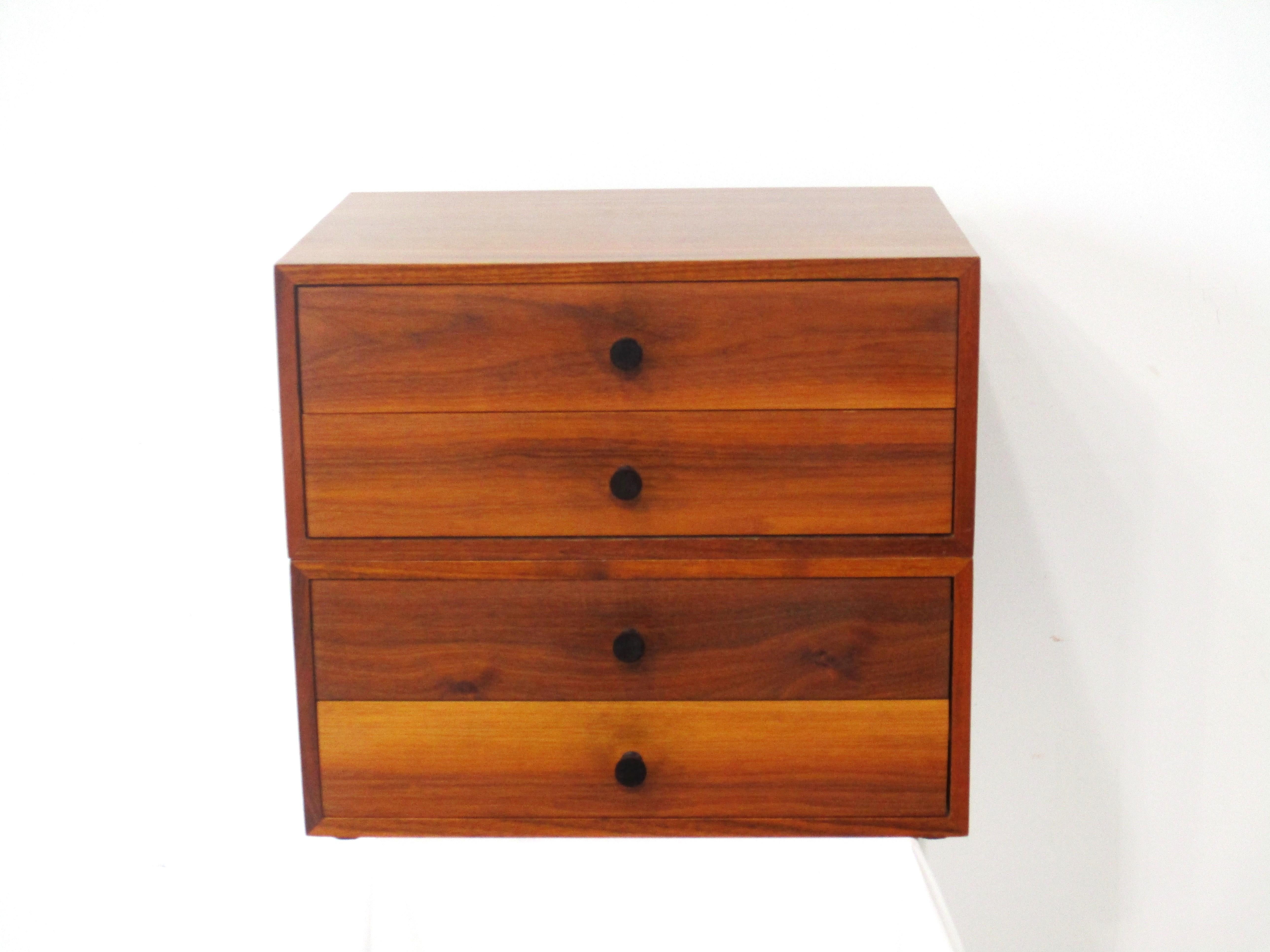 A very well crafted walnut four drawer jewelry or watch box with wonderful graining which sits on your dresser or in your dressing area . To the front of the drawers are dark turned rosewood pulls giving the piece a rich tailored look , Made in