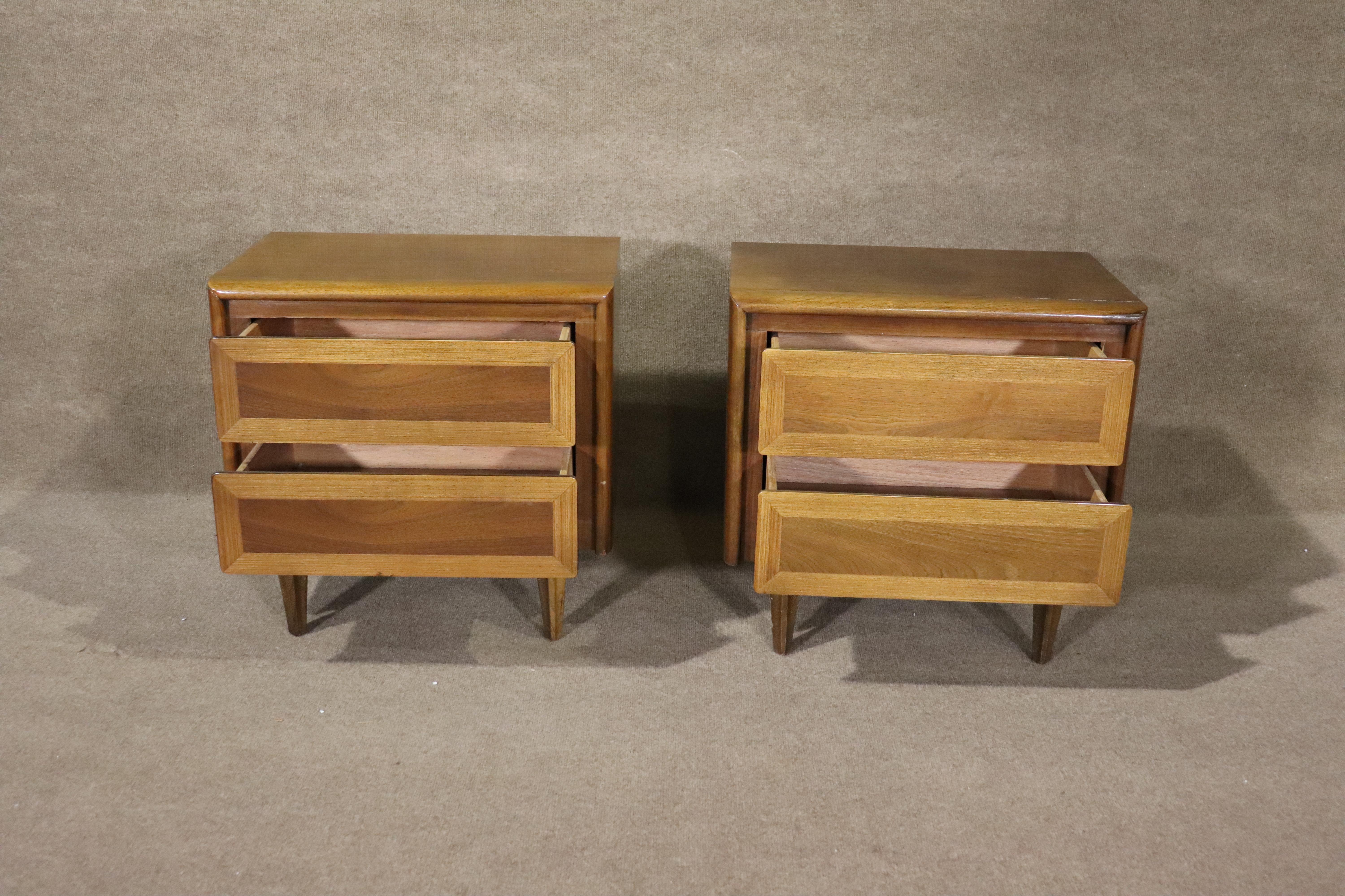 Pair of two drawer nightstands by American of Martinsville. Warm walnut grain with accepting oak trim.
Please confirm location NY or NJ