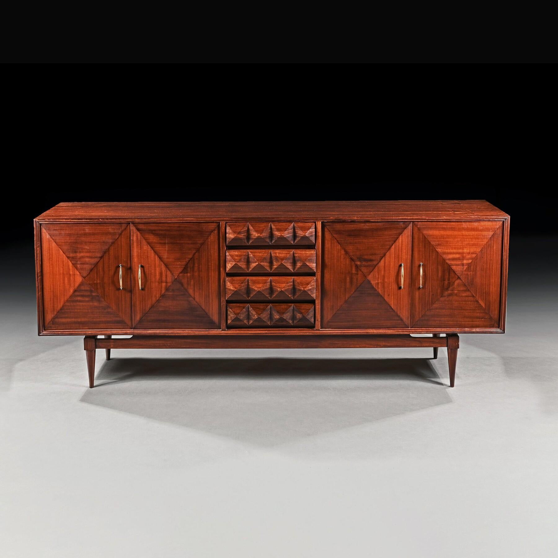An Unusual and Rare Mid 20th Century Walnut Sideboard / Enfilade with pyramid doors and drawers. 
 
Probably USA - Circa 1960

Of rectangular form with four deep pyramid styled doors flanking four central solid walnut pyramid panel decorated