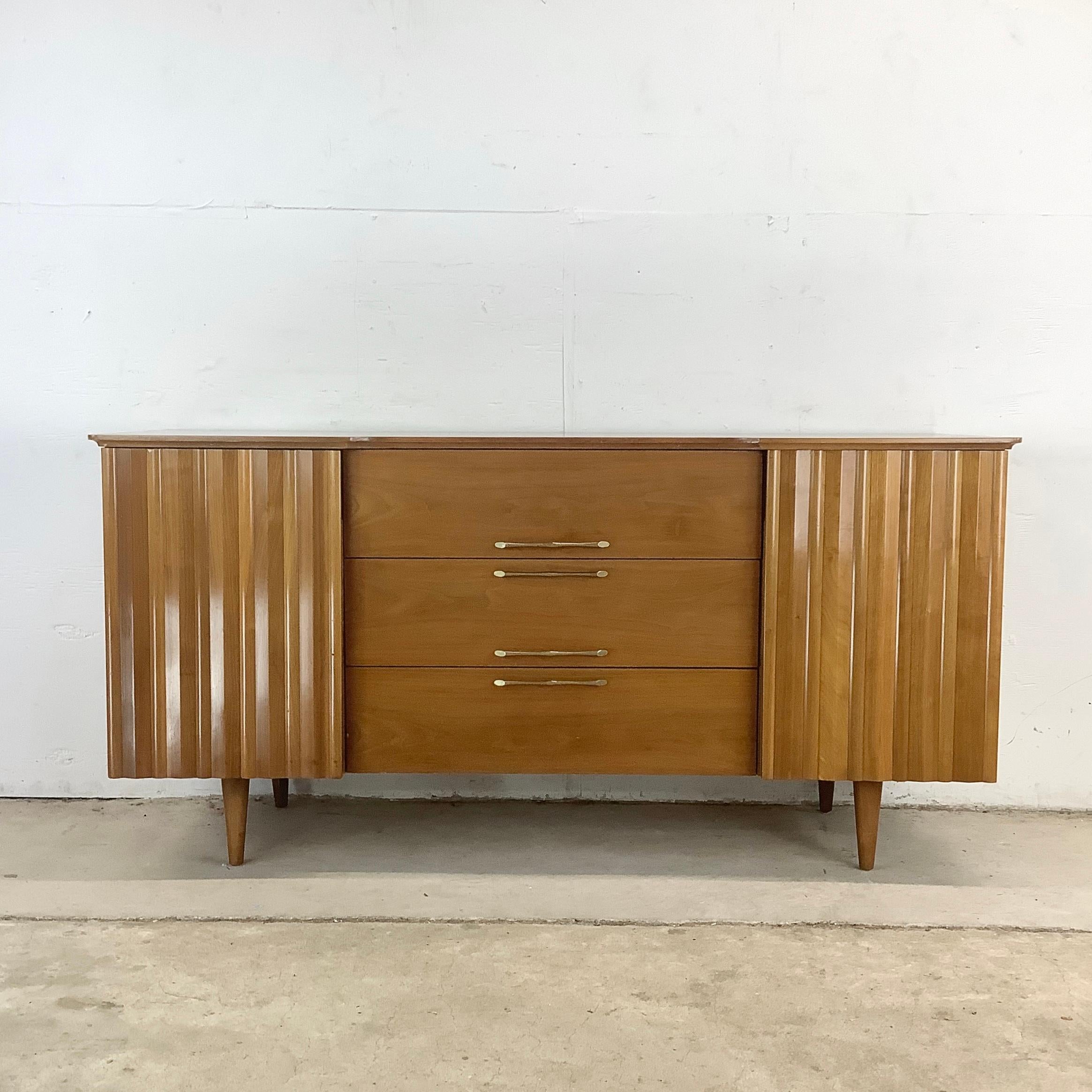 This vintage walnut finish sideboard delivers the warmth and clarity of mid-century design in a versatile, storage-rich form. Crafted  with a soft vintage finish, it’s a piece that brings function and sophistication to any room.

At its core are