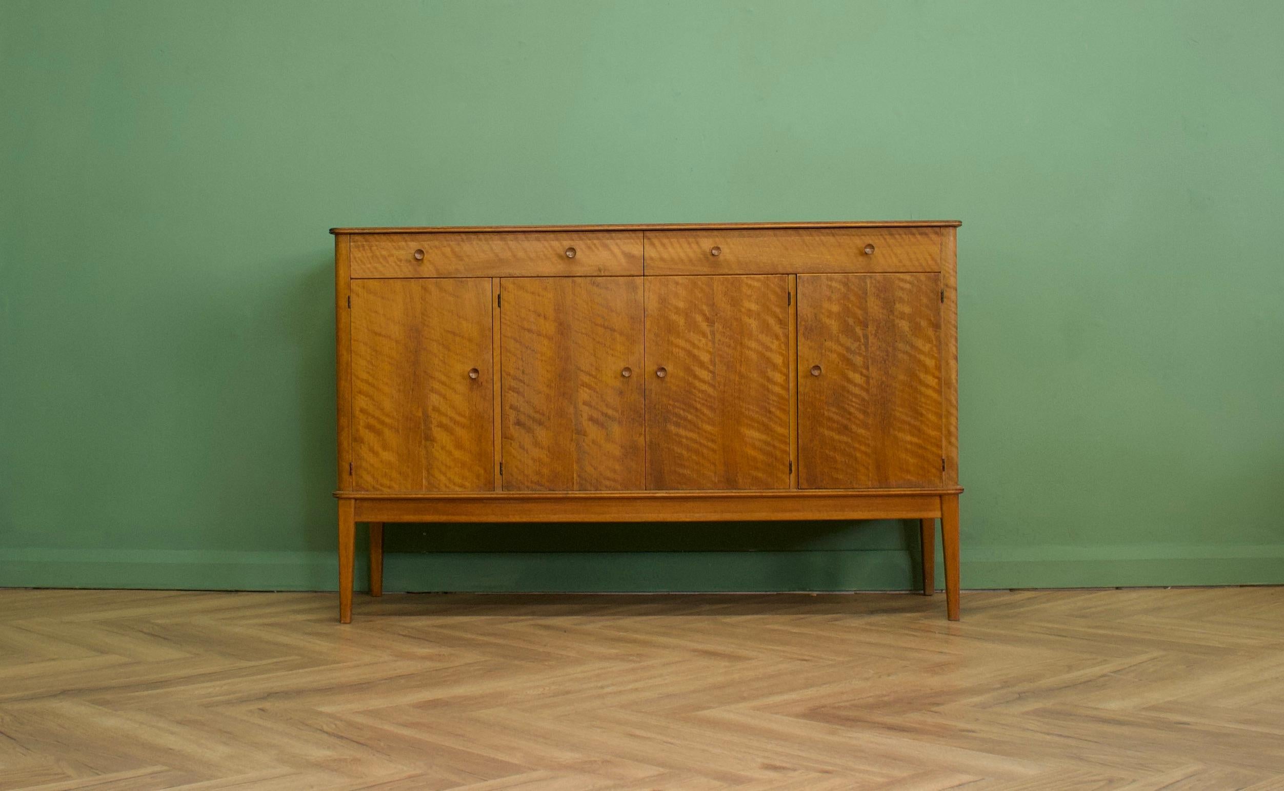 A walnut sideboard from Gordon Russell - circa 1960s
Featuring three cupboards and two drawers - the cupboards each have a removable shelf