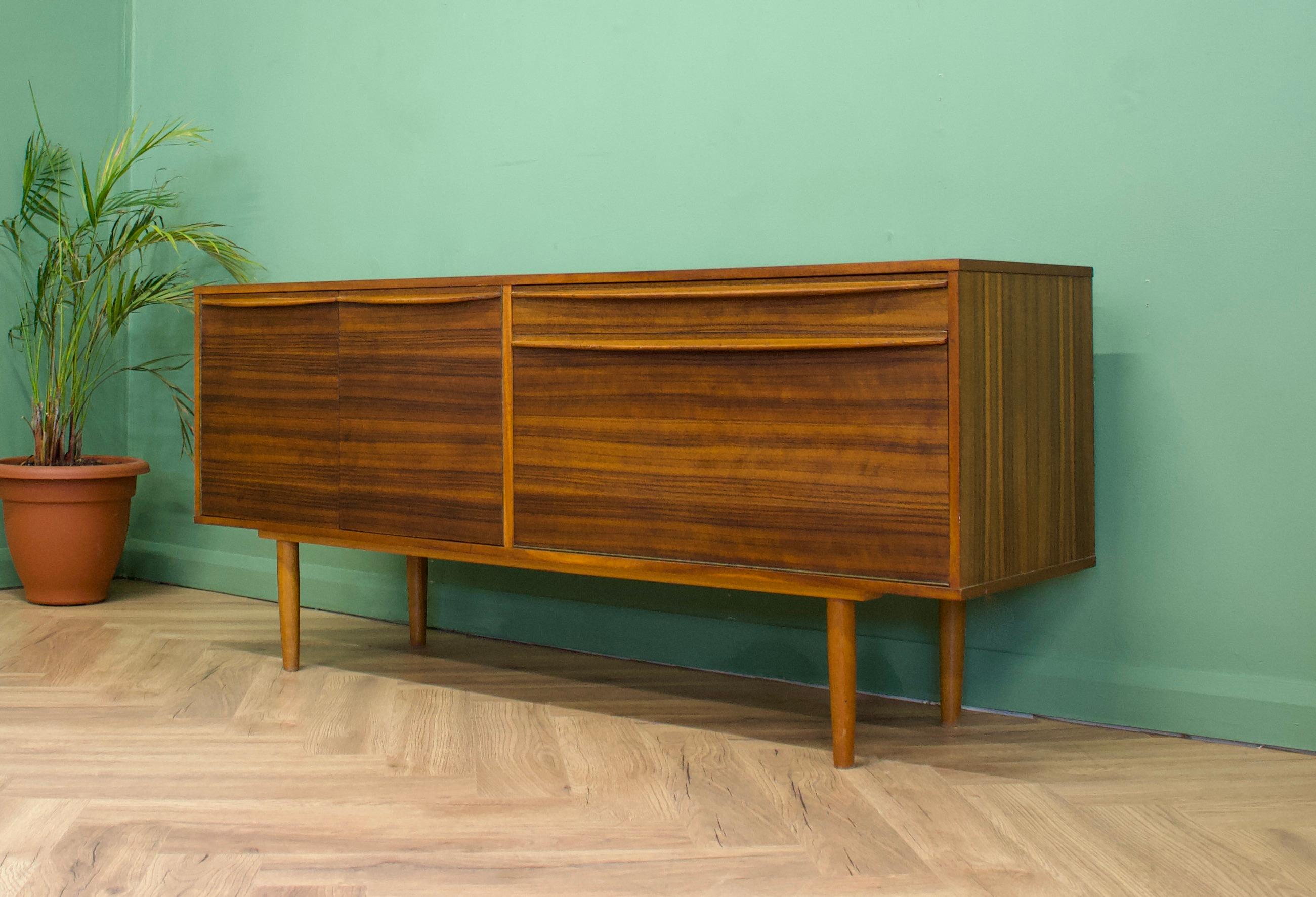 - Mid-Century Modern sideboard - dating from the 1950s.
- Manufactured in the UK by Morris of Glasgow - from the Cumbrae range.
- Featuring a drawer and two cupboards.