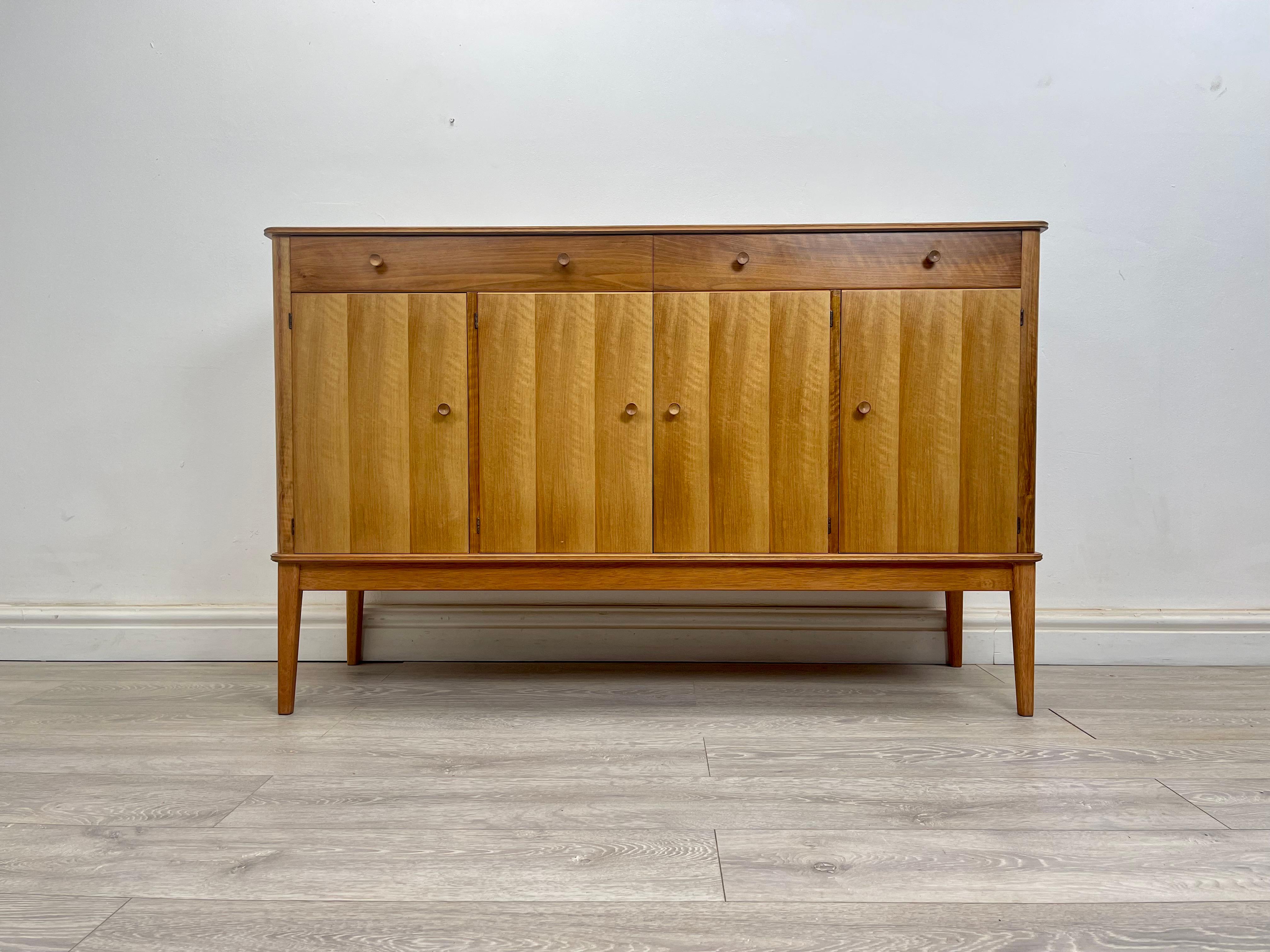SIDEBOARD 
Mid century walnut sideboard by Gordon Russel circa 1960 . 

The sideboard has stunning grain throughout , stands on square tapered legs . There’s three cupboards two with removable shelves , two drawers above all run smoothly.