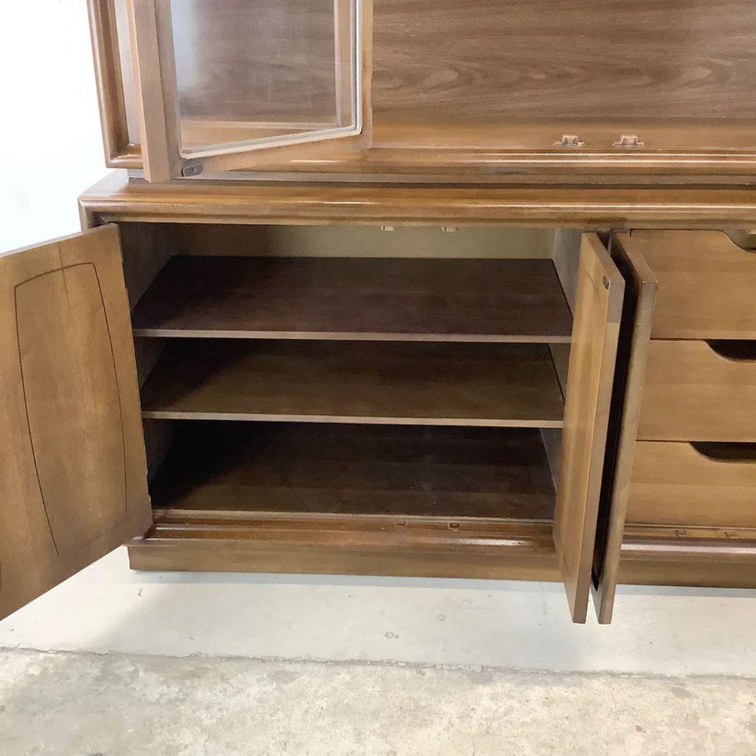 This stylish midcentury sideboard with china cabinet display top features decorative door fronts in Broyhill 