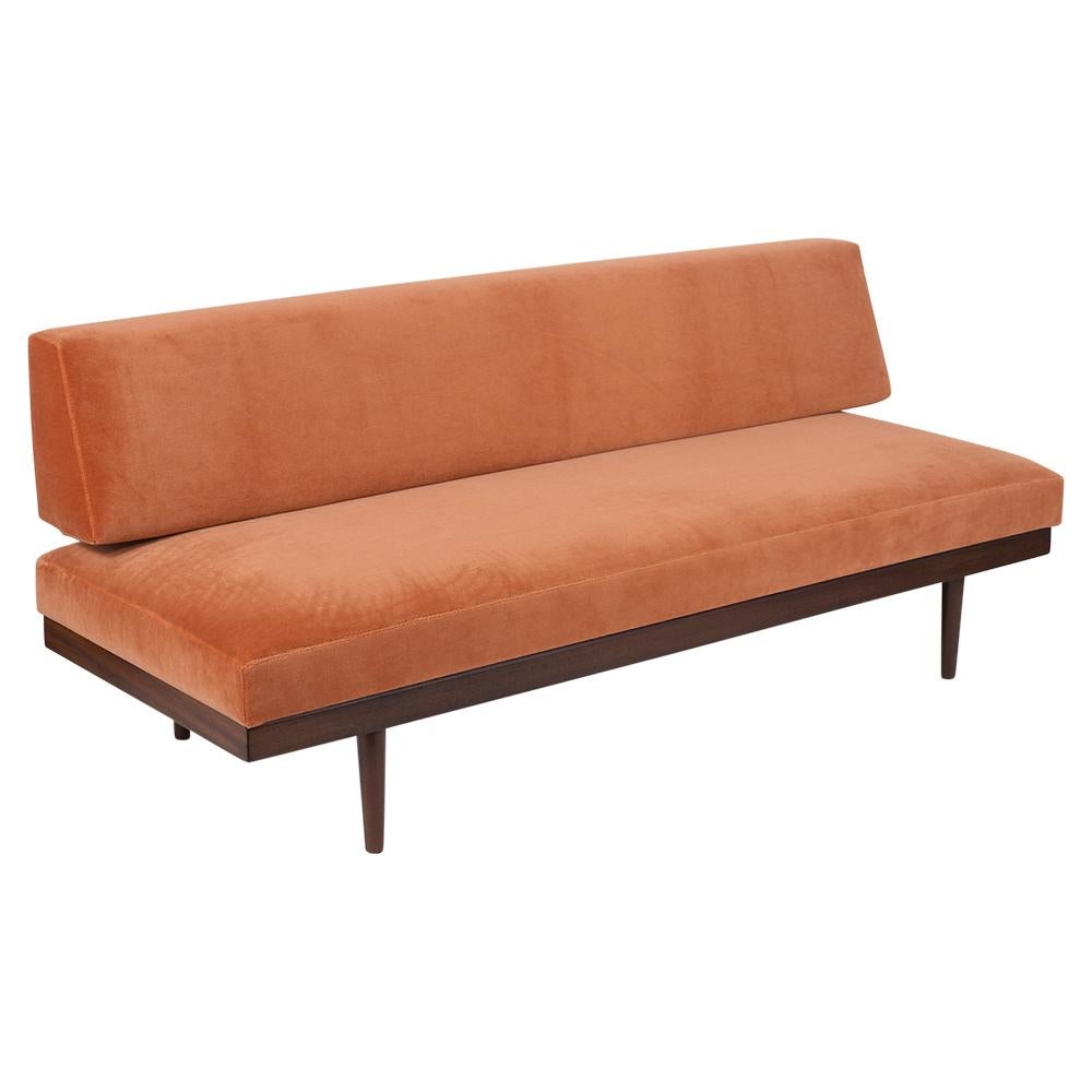 A Modern Danish Style Sofa crafted from walnut wood newly stained in a dark walnut color with a lacquered finish and has been newly restored. The loveseat features a slatted backrest, a beach seat resting on four carved tapered legs, and comes with
