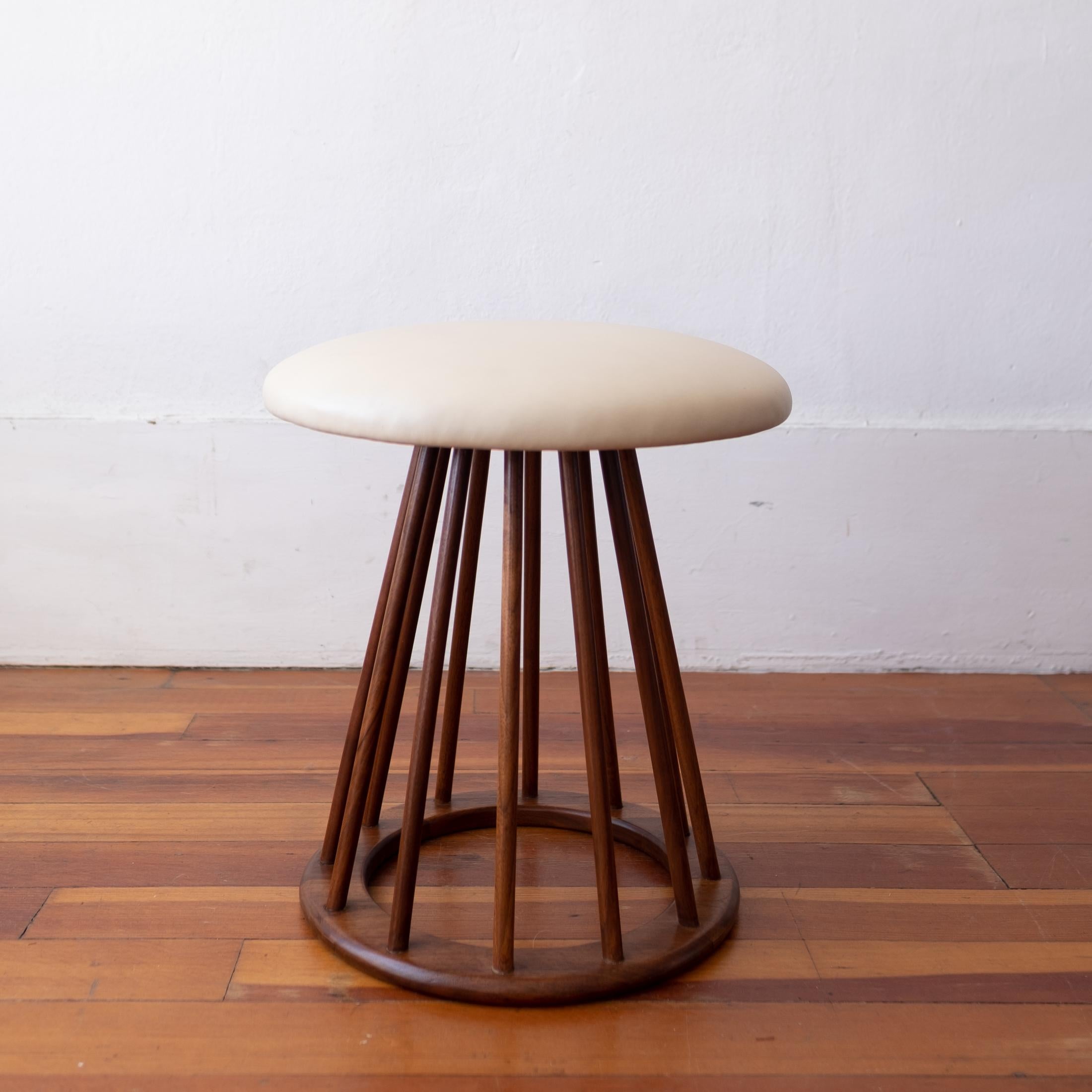 Vintage round spindle stool designed by Arthur Umanoff for Washington Woodcraft. Off white Naugahyde upholstery in excellent condition. 1960s.