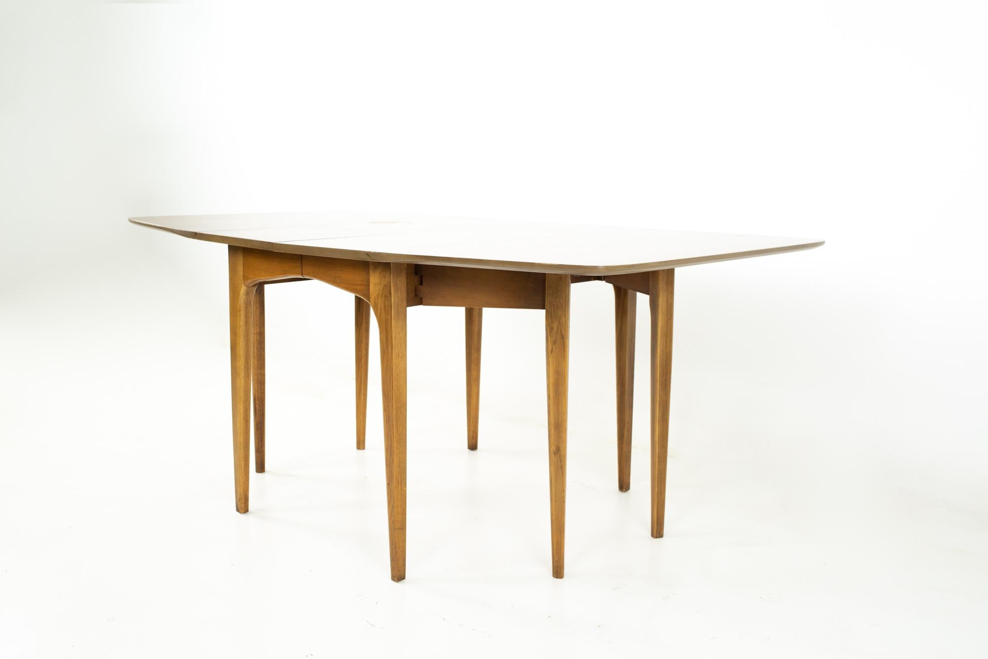 Mid century walnut surfboard drop leaf dining table
Table measures: 70 wide x 42 deep x 30 inches high, with a chair clearance of 26 inches 

All pieces of furniture can be had in what we call restored vintage condition. That means the piece is