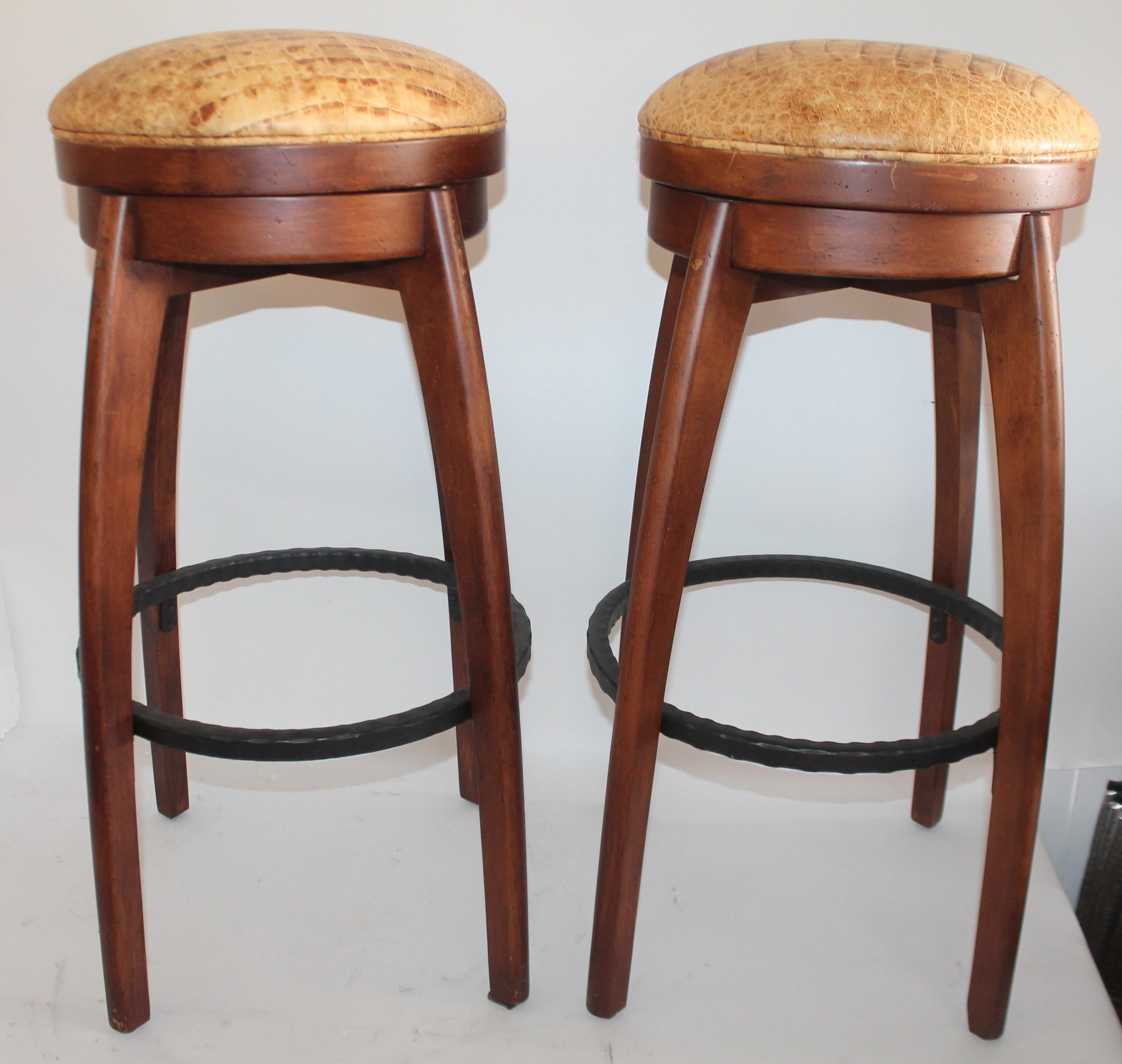 These amazing walnut framed swivel bar stools are in fantastic condition and have leather seat cushions.