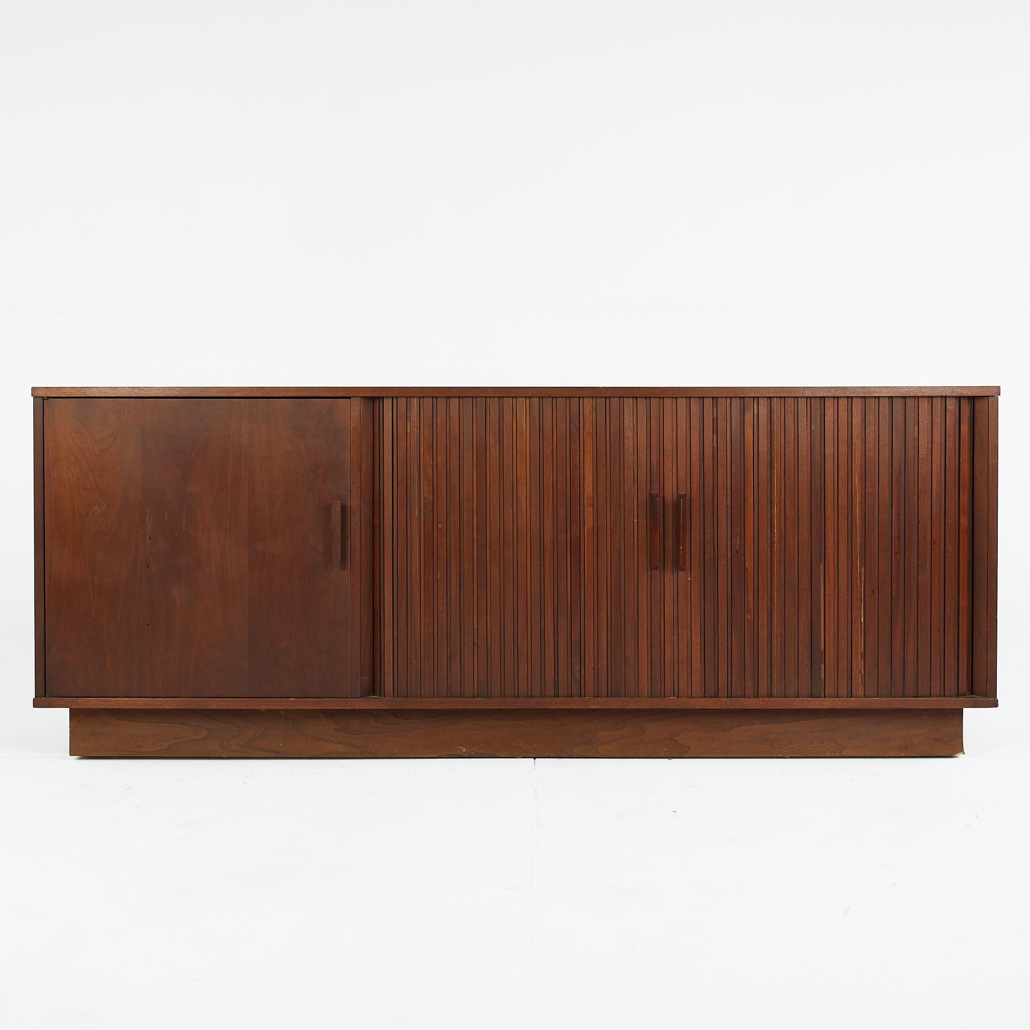 Mid Century Walnut Tambour Door Credenza

This credenza measures: 72 wide x 18.5 deep x 28.5 inches high

All pieces of furniture can be had in what we call restored vintage condition. That means the piece is restored upon purchase so it’s free