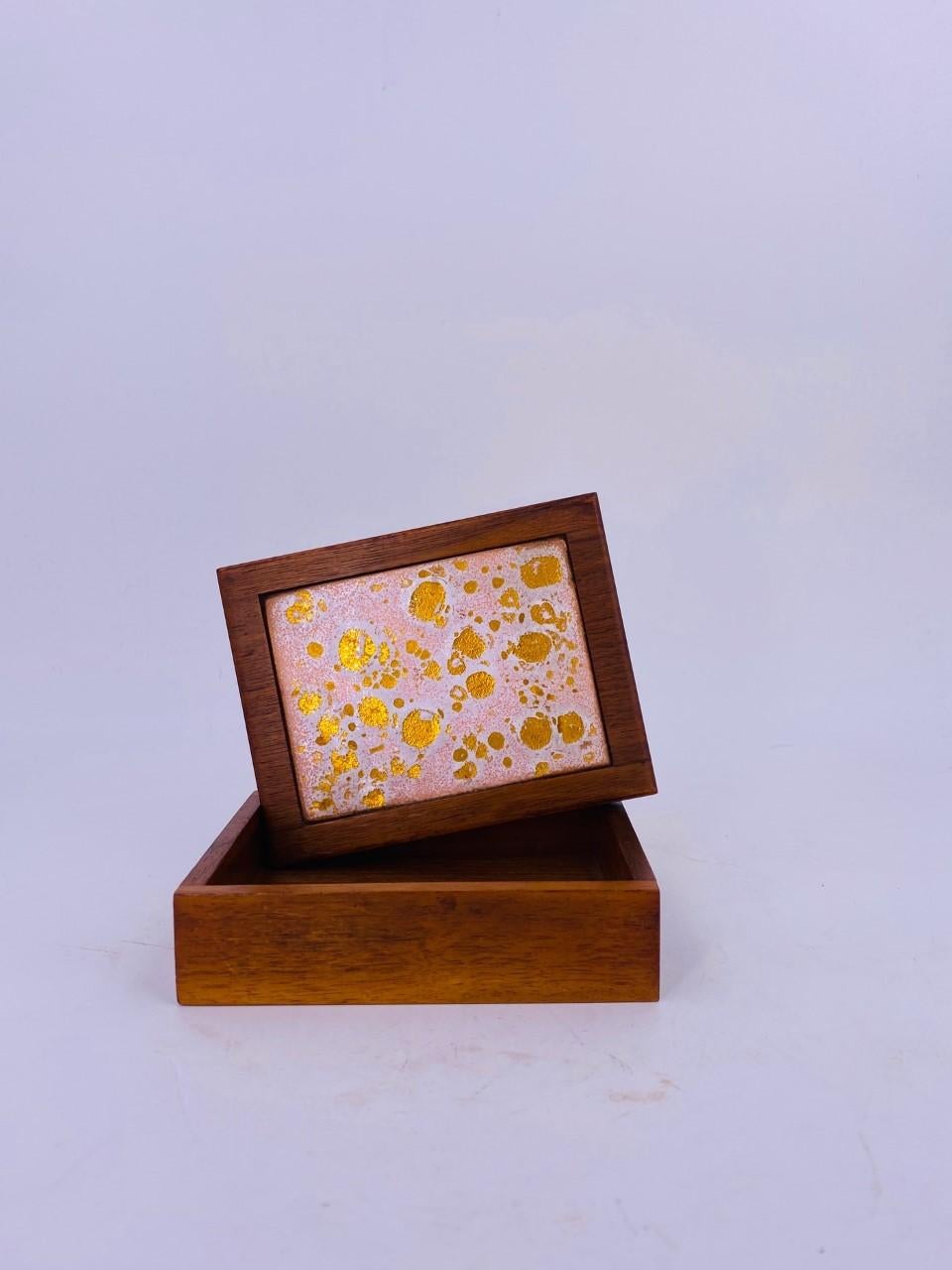 Beautiful and unique midcentury walnut box with ceramic inlay top. This beautiful box can be used for jewelry or any type of cherised small items or just by itself is a beautiful piece. Solid walnut pieces with a ceramic inlay in beautiful gold