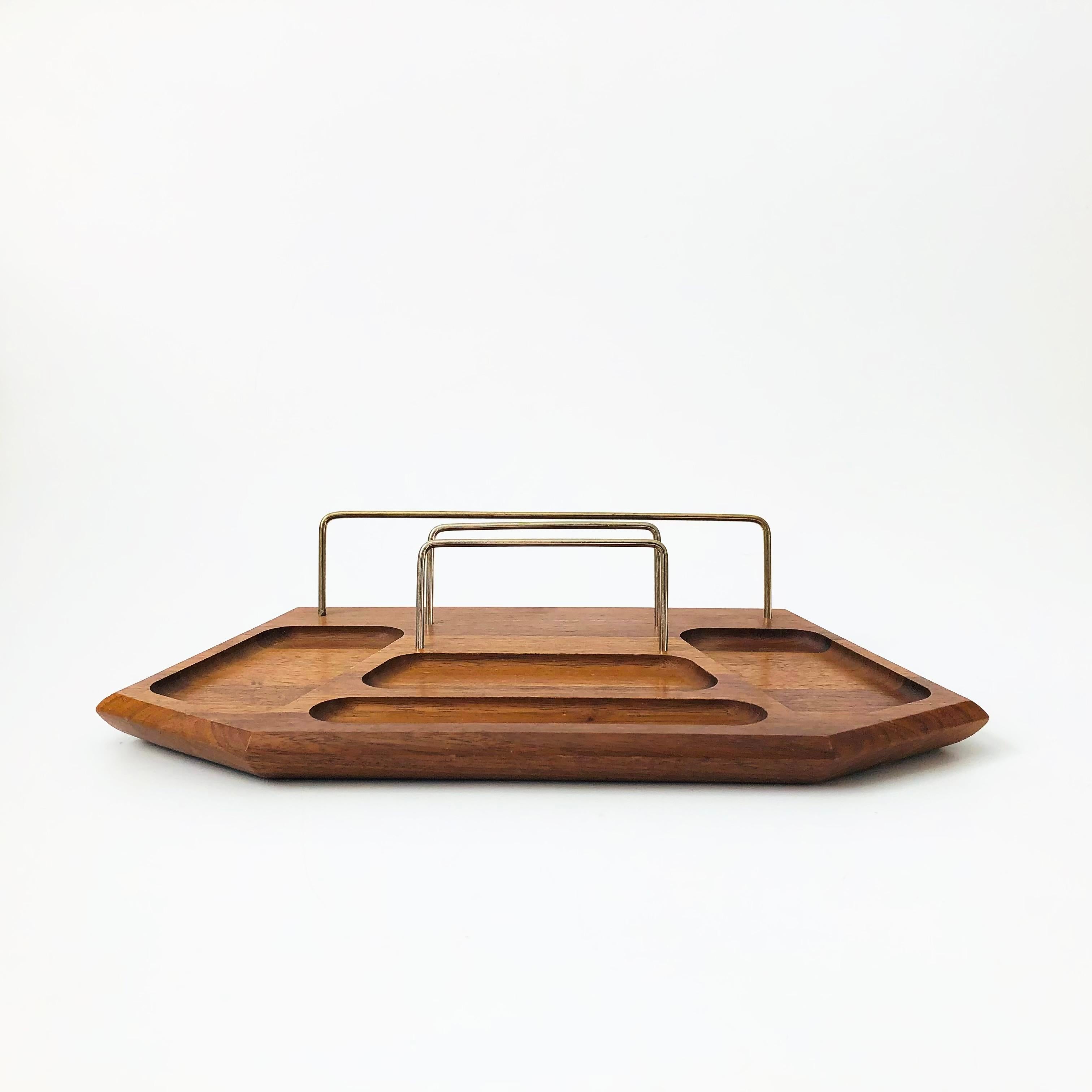 A vintage walnut valet to meet all your organizing needs. Features several inset areas for organizing small items and brass bars for holding paper. Unique faceted shape. A great organizational piece to keep in the office, bedroom, or entryway.

