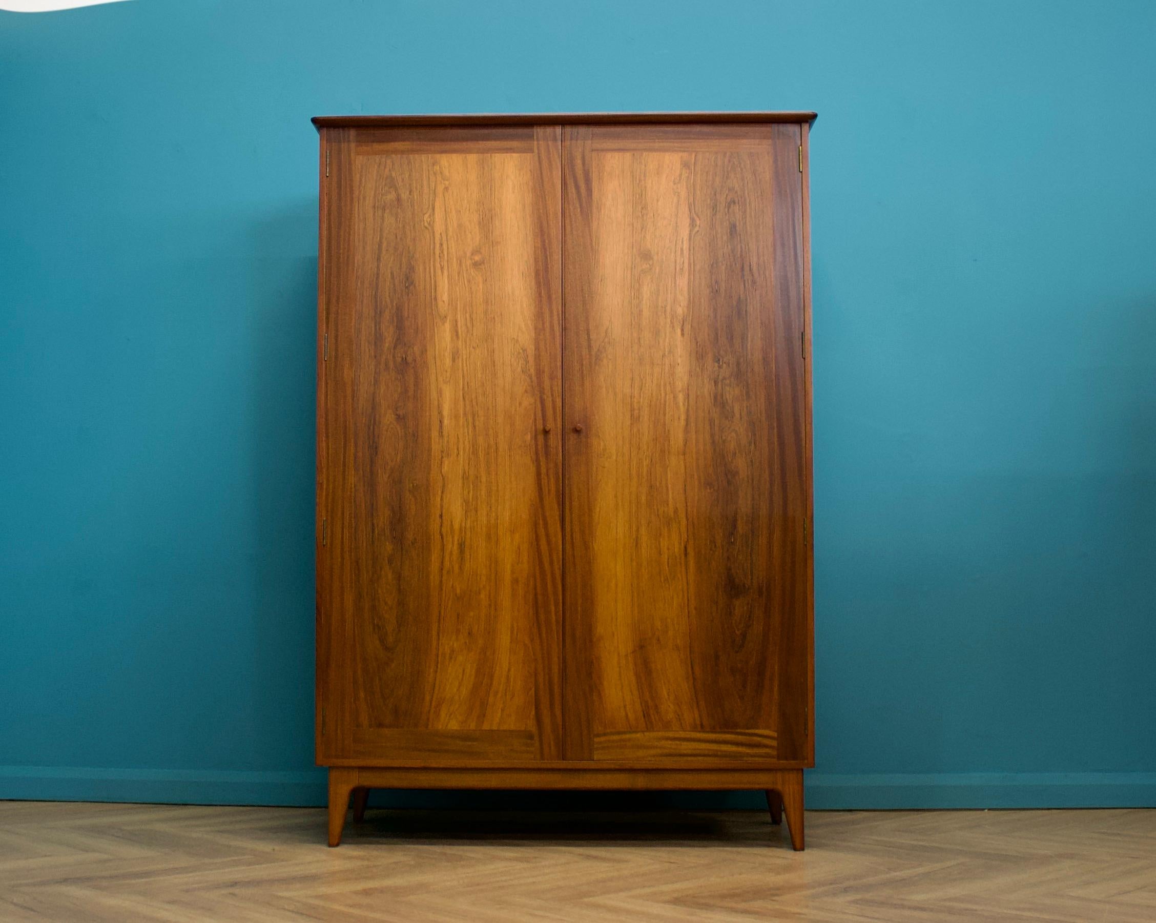 A beautiful quality freestanding wardrobe by Younger - retailed through Heals - circa 1950s
Internally there is a brass rail and a full length mirror