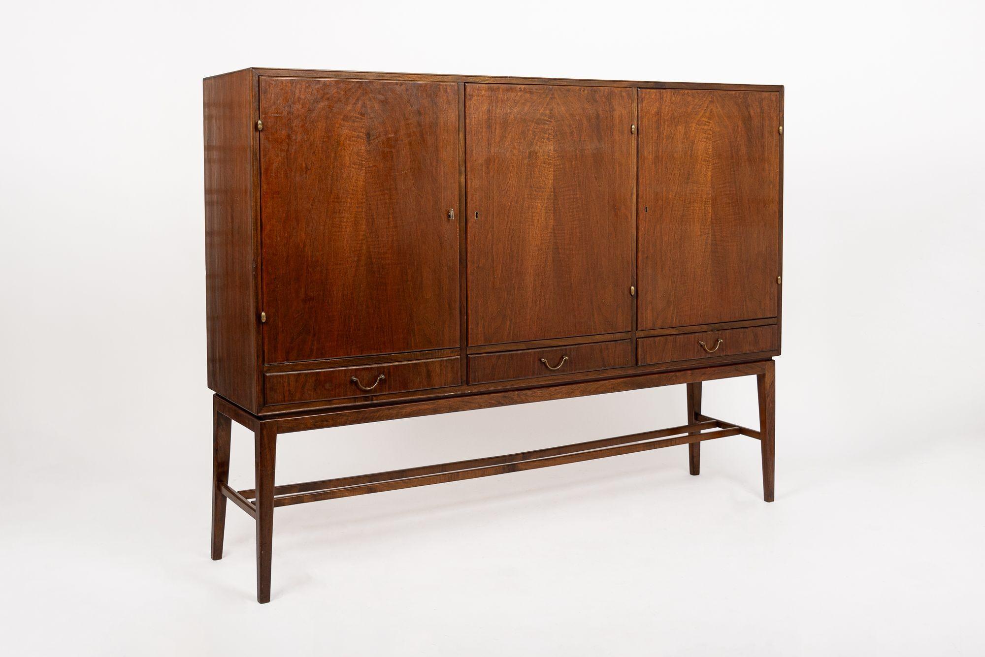 This vintage mid century credenza modern tall cabinet credenza or sideboard cabinet attributed to Frits Henningsen was made in Denmark circa 1960. This cabinetmaker style credenza or server features classic Danish modern styling with a minimalist