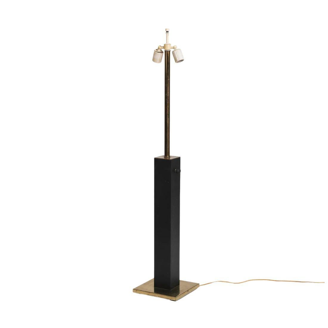 A vintage mid century, tall Walter Von Nessen leather and brass column table lamp. Minimalist in style, the lamp features an architectural square leather column sitting on a flat square brass base. Modernist light quite functional with  two sockets.