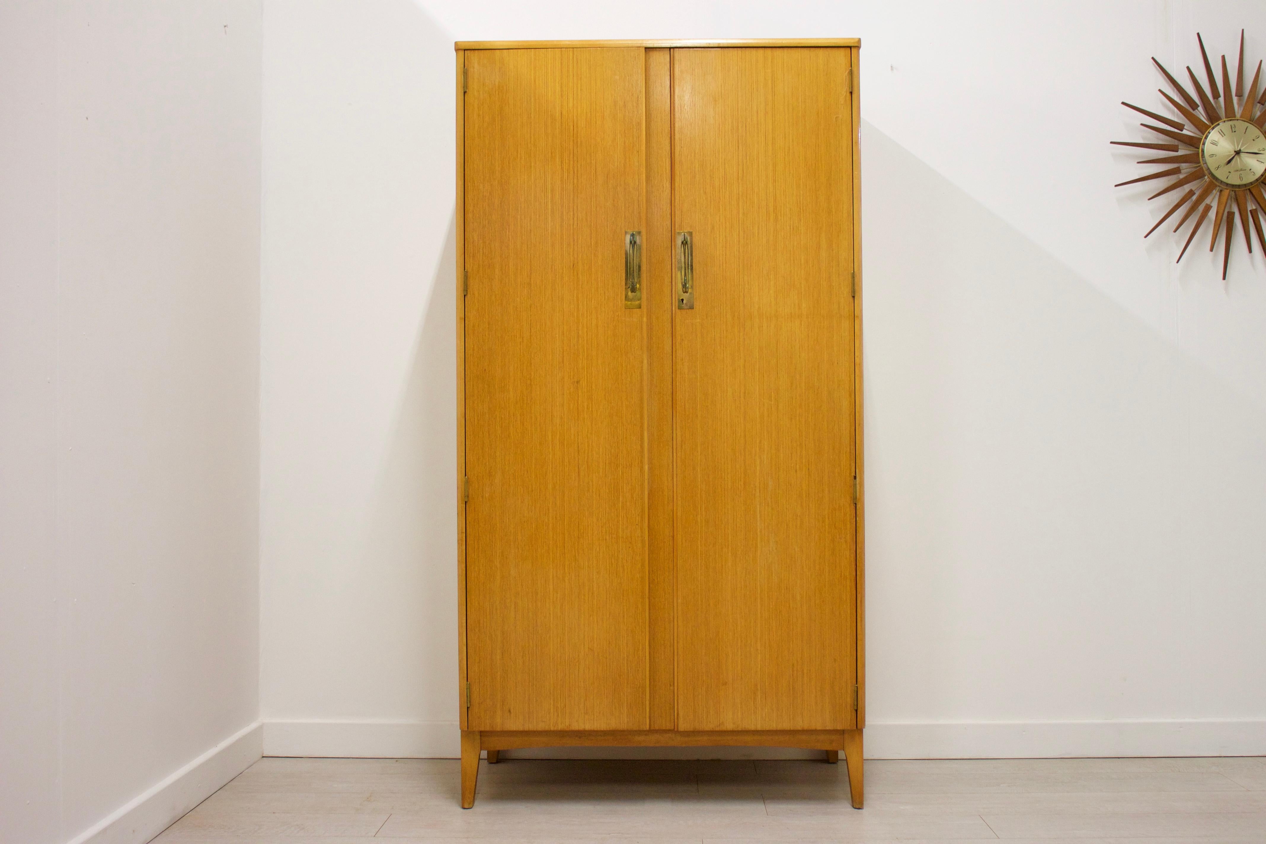 - Mid-Century Modern wardrobe
- Manufactured by Remploy
- Featuring a hanging rail to the left, shelf to the right, and an additional rail underneath.