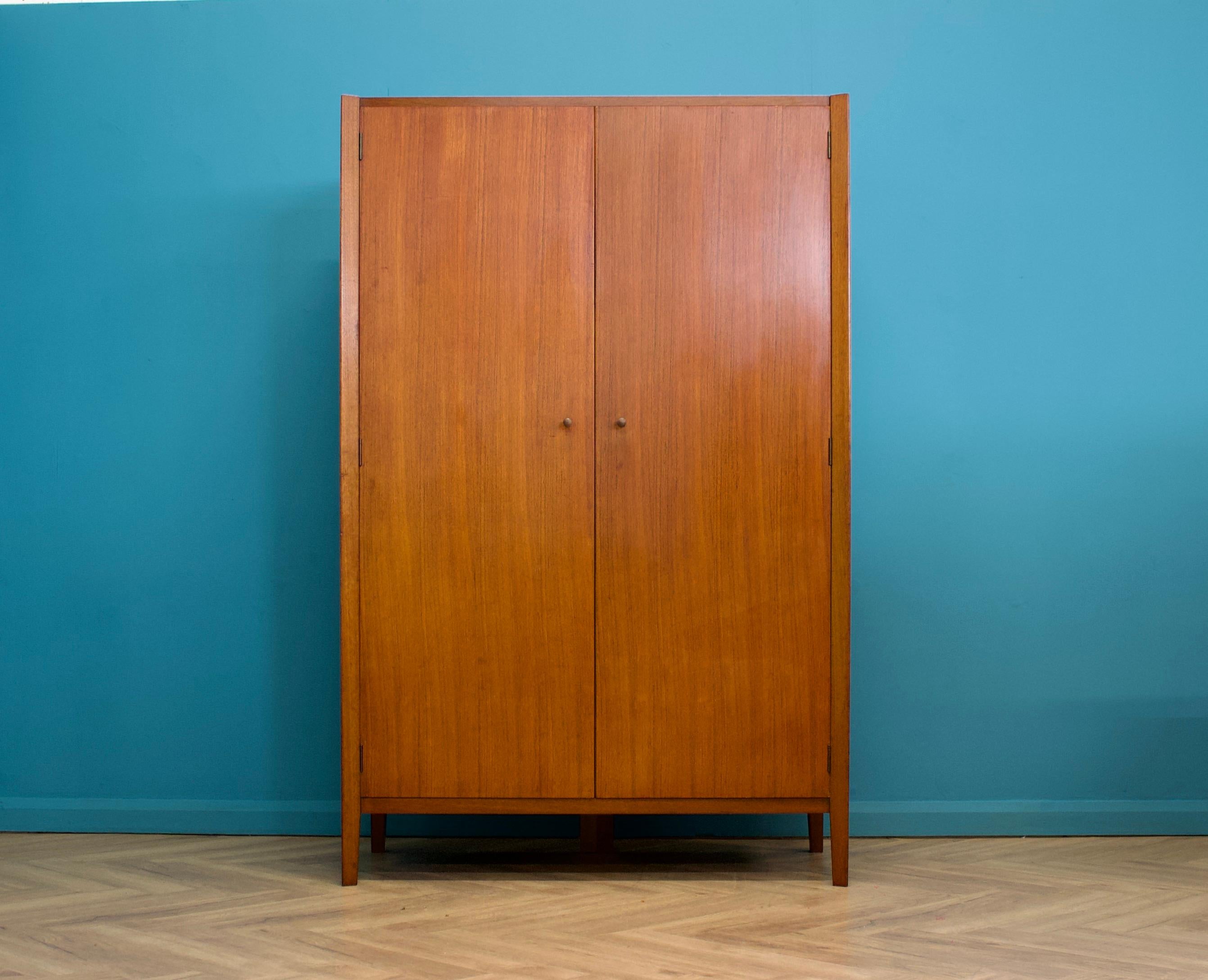 A rarely seen, freestanding double door teak wardrobe from Gordon Russell  - in the Danish modern style
The quality is exceptional
Made during the 1960s Fitted out with two clothes rail and fixed shelving for ample storage.
The style of this