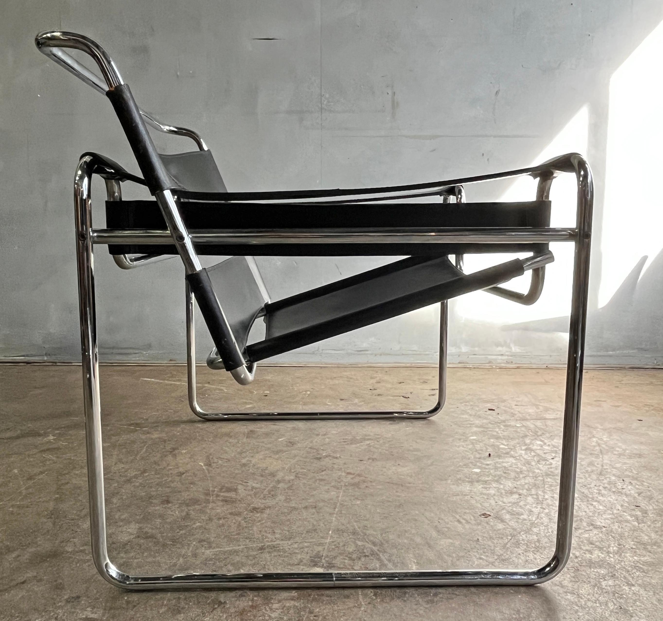 Wassily lounge chair designed by Marcel Breuer in black full leather. This vintage chair has the traits for authenticity verification such as flat caps on the end tubes, black hex screws, and thick cowhide leather. 

Marcel Breuer's 1925 iconic