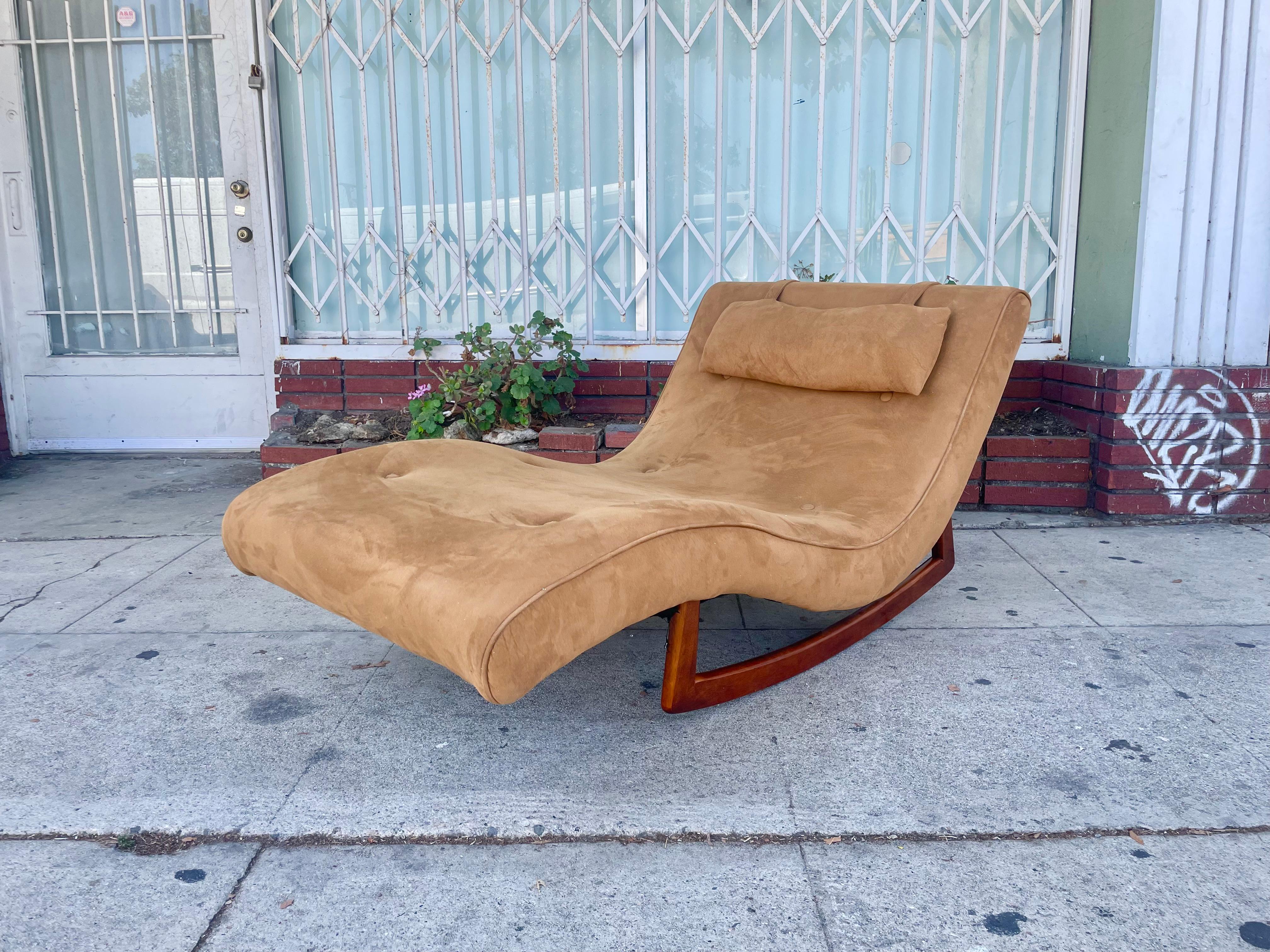 Beautiful mid-century wavy rocker styled after Adrian Pearsall design and manufactured in the United States circa 1960s. This beautiful wavy chaise lounge features a walnut base with beautiful brown upholstery, guaranteed to draw attention in any