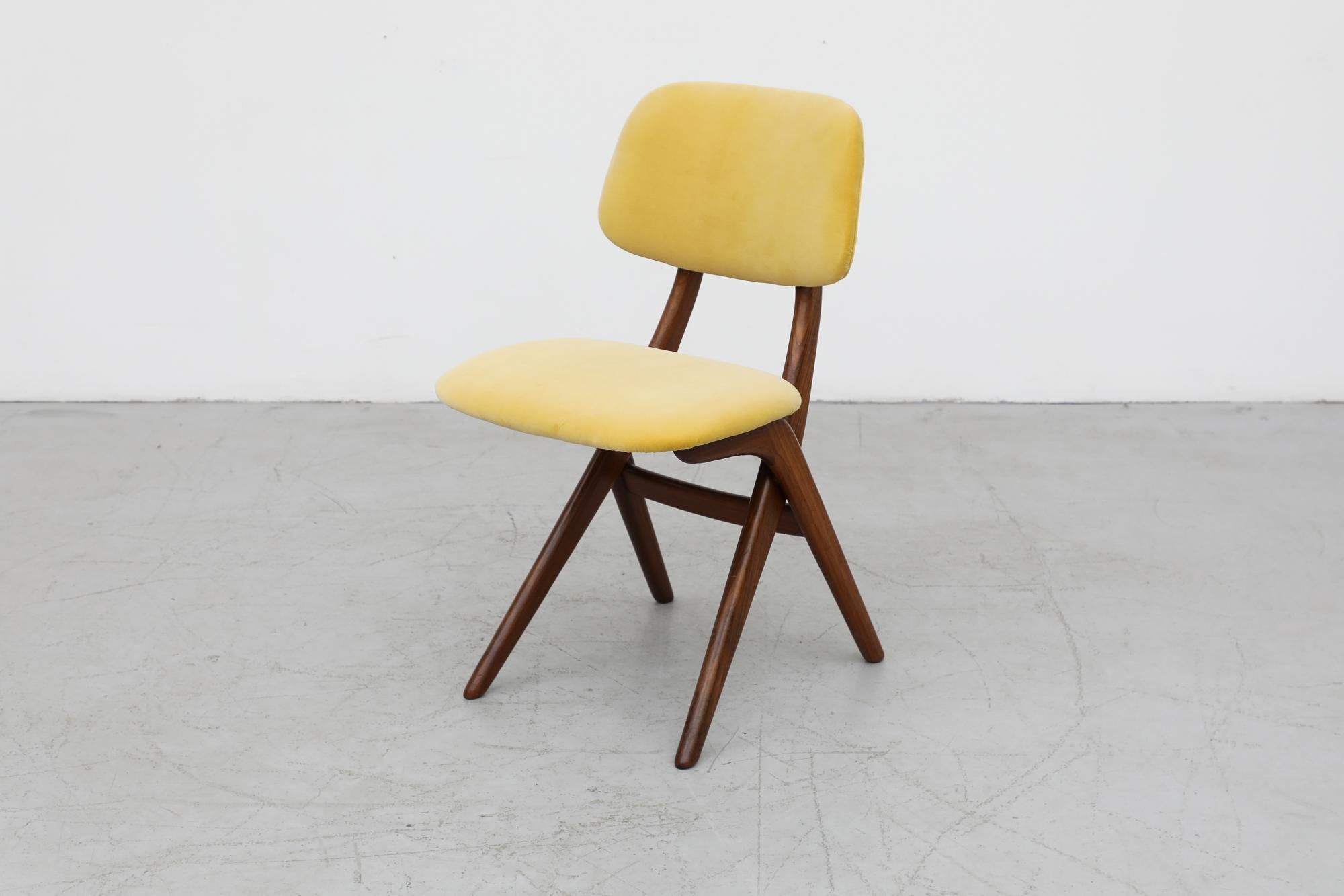 Louis Van Teeffelen side chair with yellow velvet upholstered seats and lightly refinished teak frame. This chair is a prominent part of the scissor series well known for its sleek design and comfort. Similar chairs also available in Olive and Kiwi