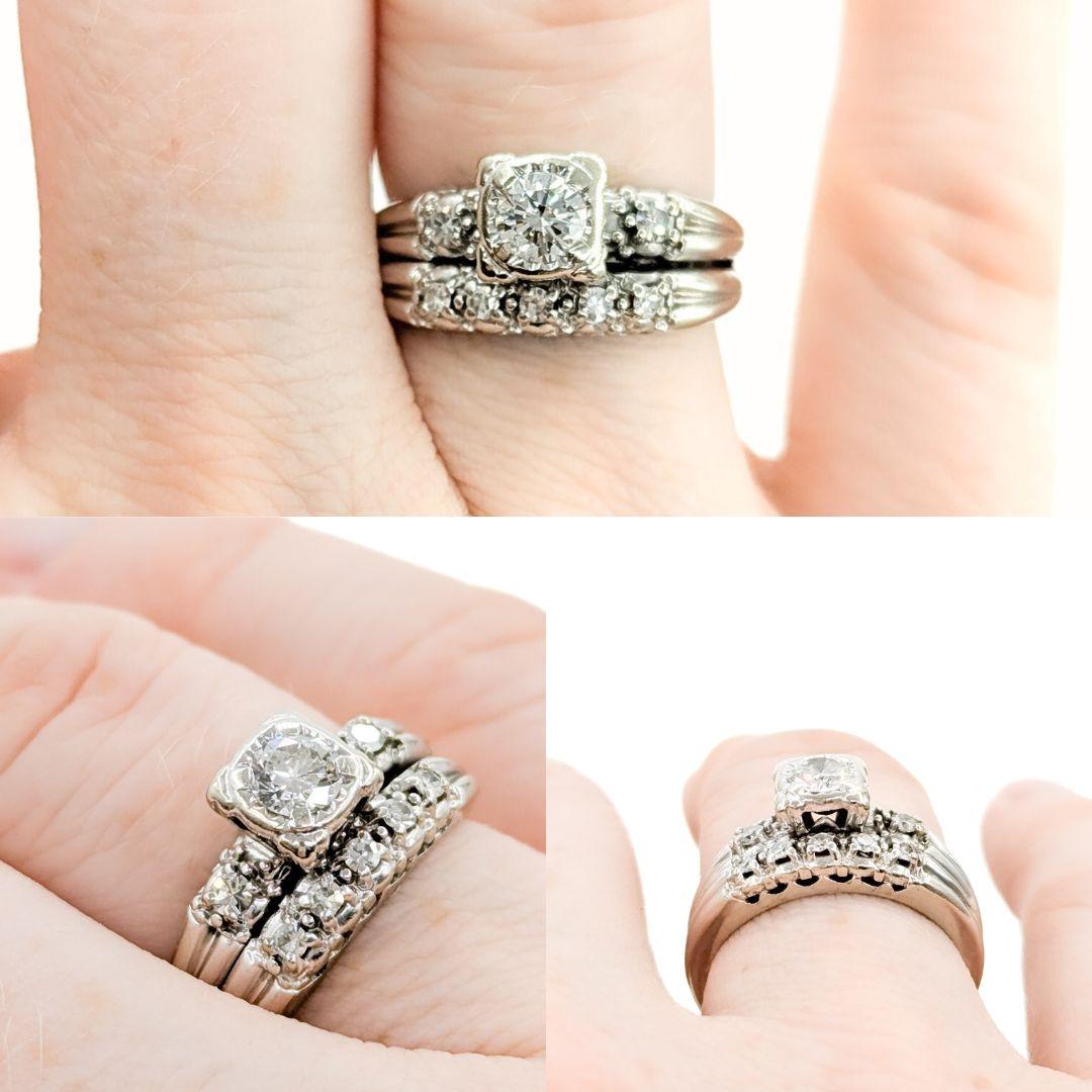 Mid Century Wedding Set Engagement Ring in White Gold

This beautiful wedding set is crafted in 14k white gold and features a 0.30ct round diamond as the centerpiece. The main diamond, with VS clarity and near-colorless brilliance, radiates