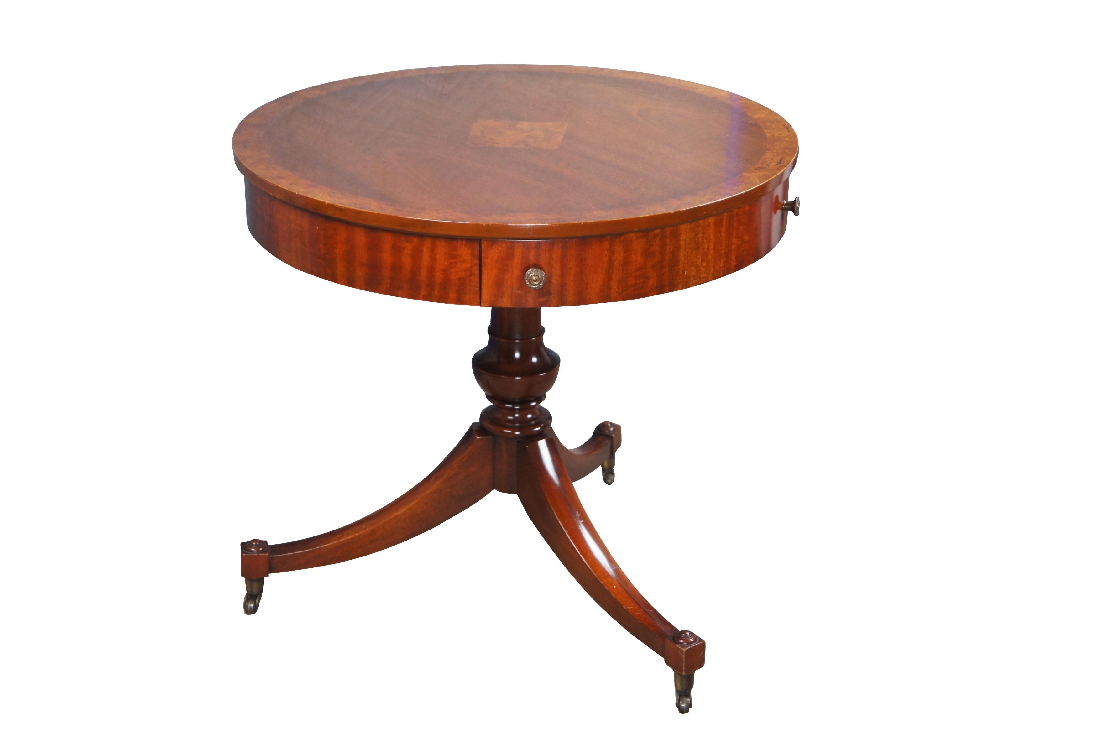 Mid Century Weiman Heirloom English Regency style drum table.  Made from mahogany with a round top featuring a diamond inlaid burled center and burled outer banding.  Includes a friezed drawer with brass pulls.  The table is set over a baluster
