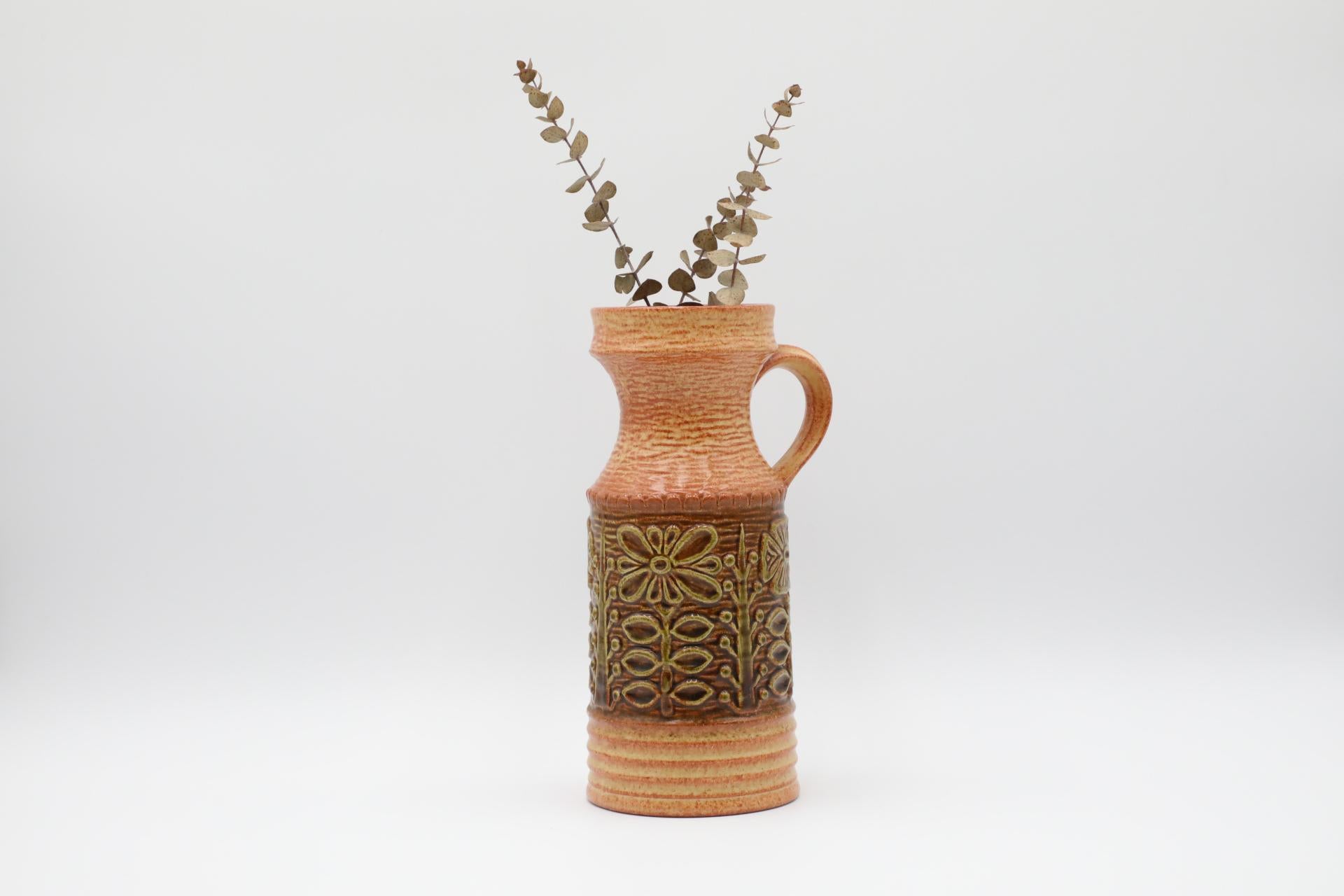 West German ceramic vase with stylized flowers and original label 'Keramikfabrik Uebelacker Ransbach/Westerwald. Marked 1835/25 401' on bottom. Wear consistent with its age and use.