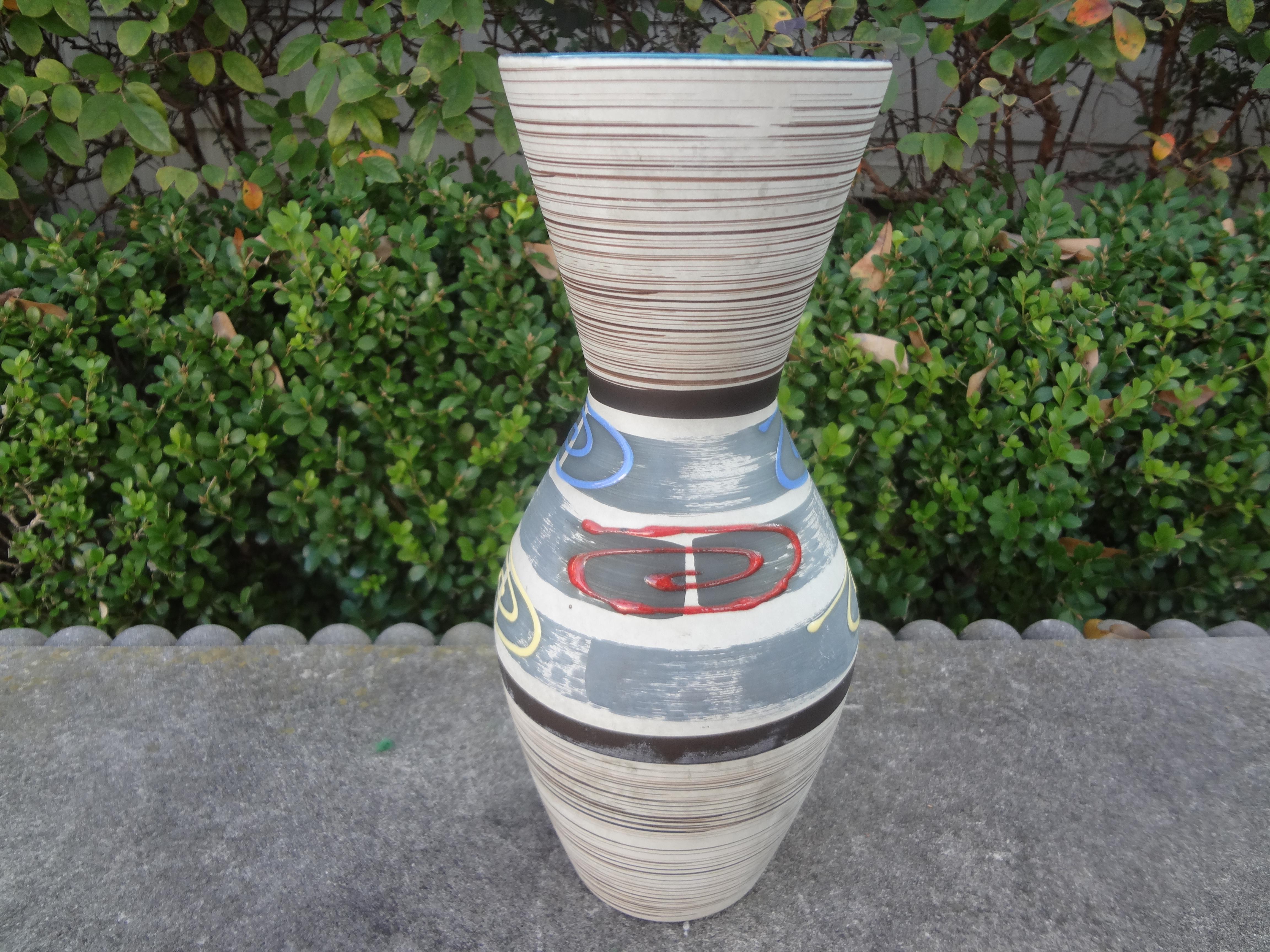 Midcentury West German glazed pottery vase.
Stunning West German glazed pottery vase. This vase has gorgeous geometric shapes in blue, red and yellow.