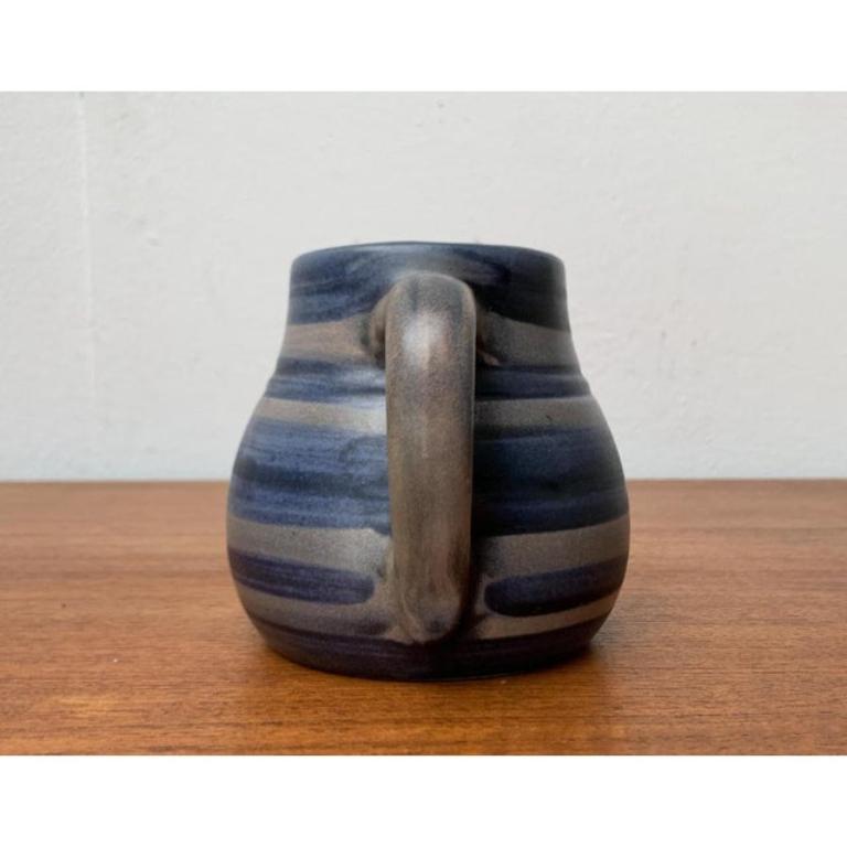 Mid-Century West German Pottery WGP Jug from Knödgen-Ilkra Edelkeramik, 1960s, in Very Good conditions. Designed 1960 to 1969 This piece has an attribution mark.

Additional information:
Materials: Ceramic
Color: Blue
Styles: Mid-Century