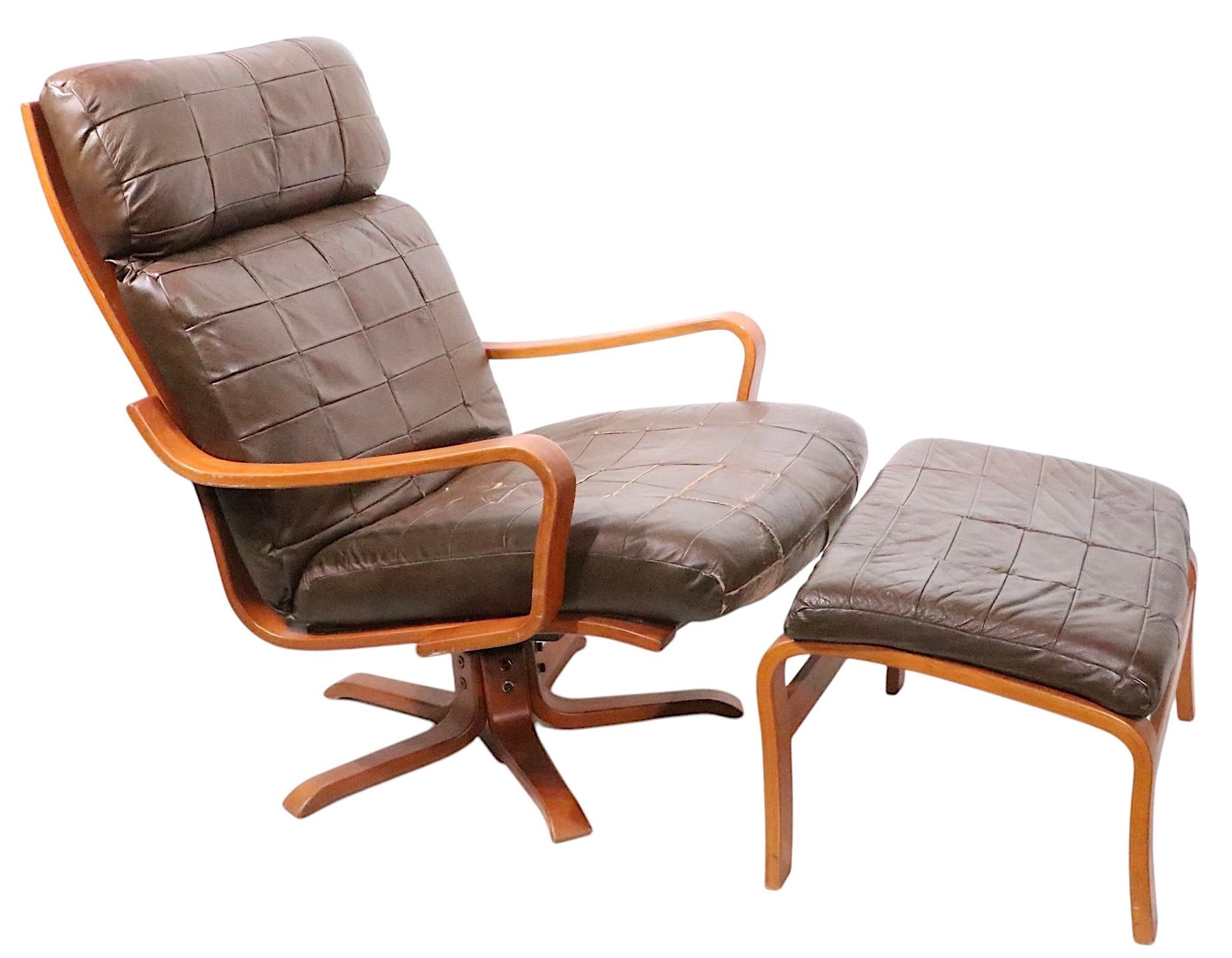 Classic Scandinavian Mid Century Modern swivel, tilt lounge chair and ottoman, made in Norway by Westnofa, circa 1960's. The chair and ottoman are in very good, clean, ready to use condition, showing only light signs of age and use. 
 Chair:
Total H