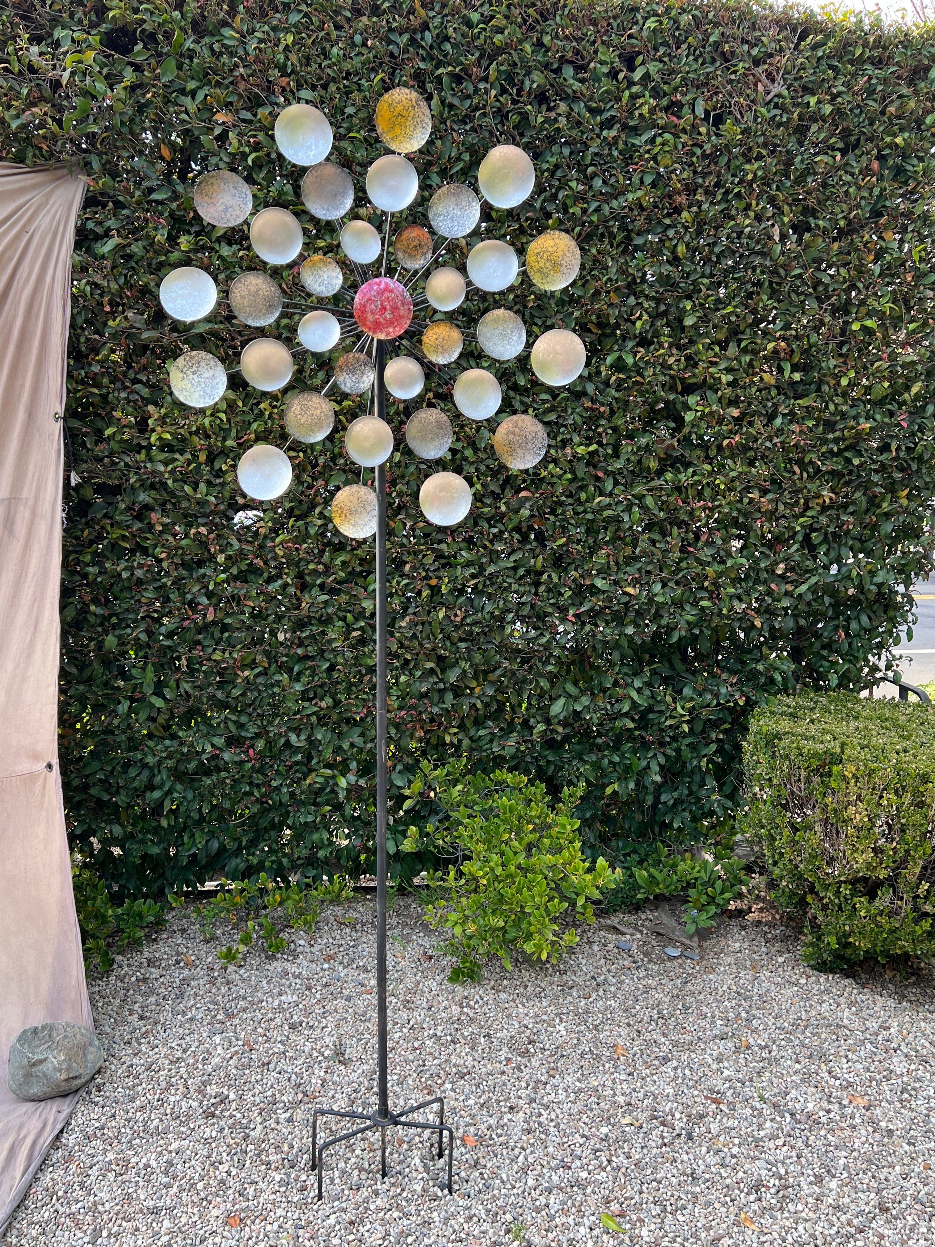 Stunning spinning garden ornament. This piece is huge - 8 feet tall - and is a calming, wise presence in any garden. The smooth spinning of the layered circles is certainly hypnotic on a breezy spring day. 

A compliment to any garden or place