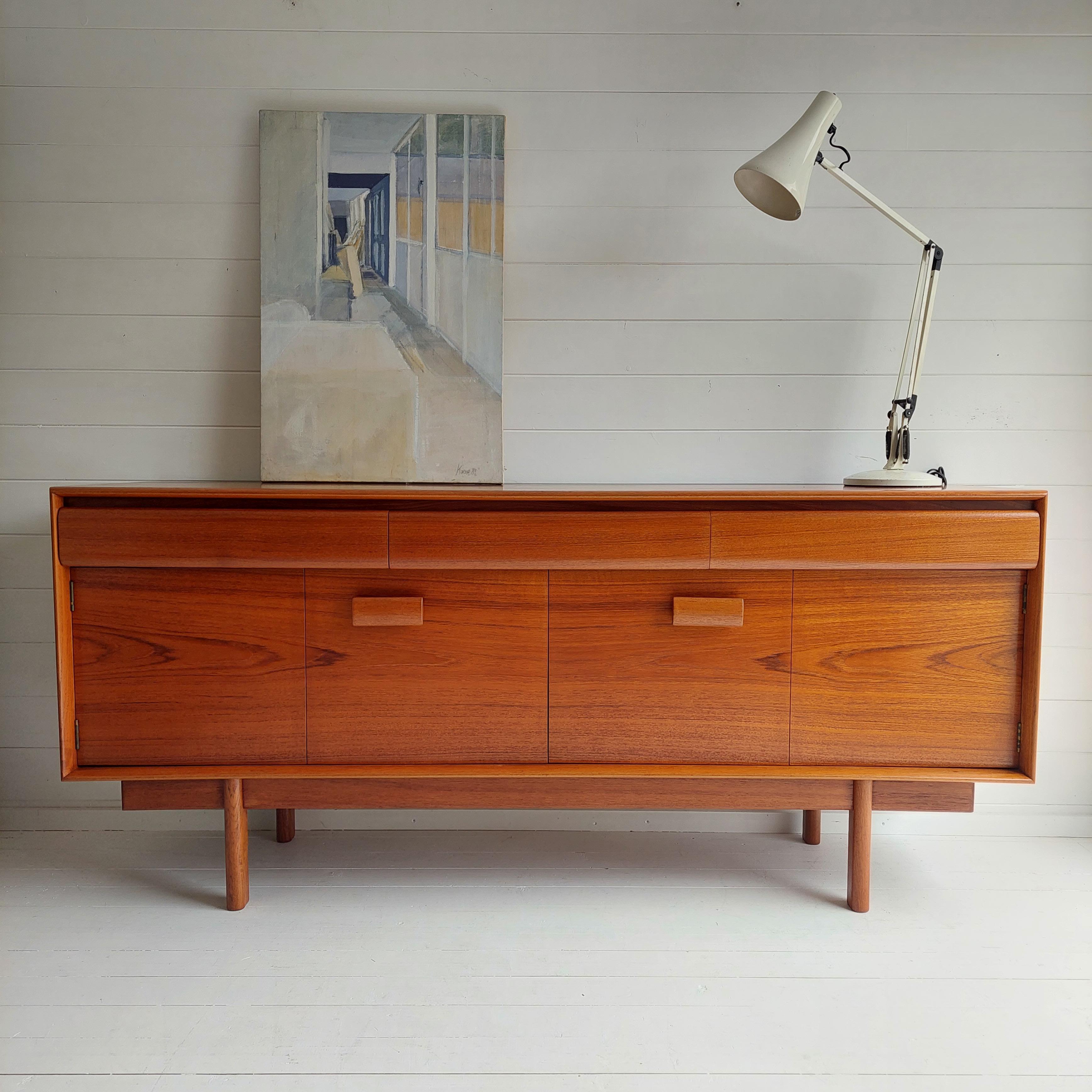 ‘Winchester’ teak sideboard by Philip Hussey for White & Newton of Portsmouth c.1965
This design features a pair of concertina doors opening to reveal a spacious interior
The piece has a spacious full width cupboard fitted with a full-width