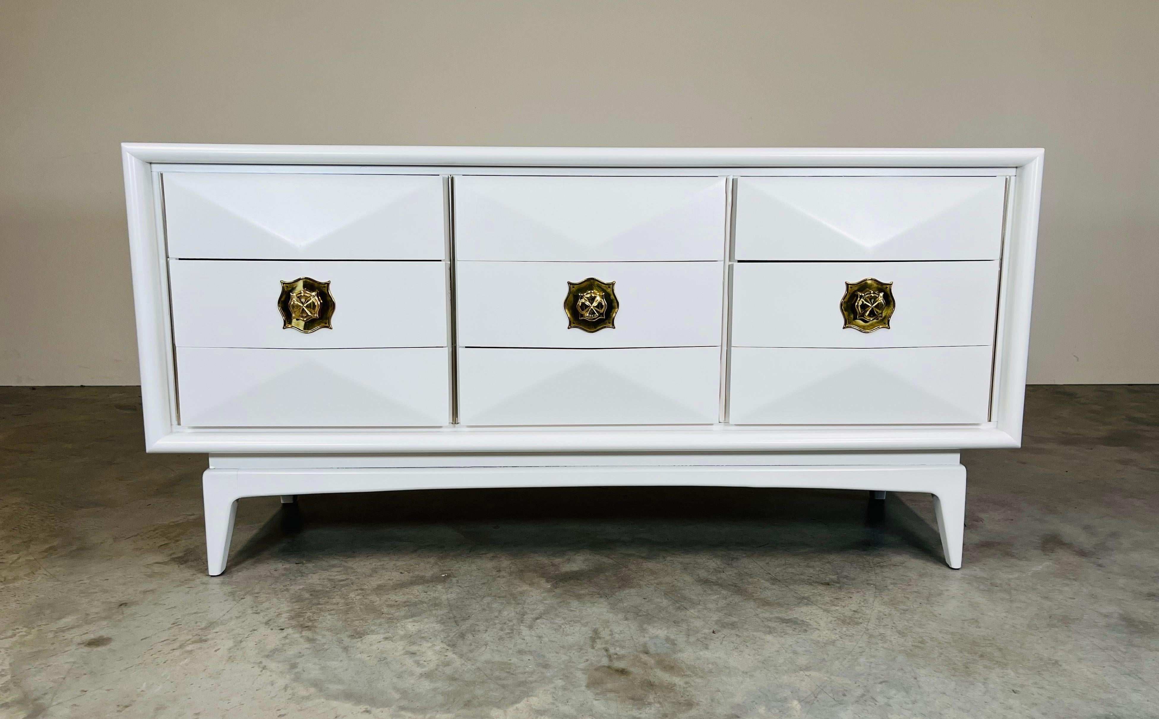 A stunning mid-century modern 9-drawer dresser having sculptural convex diamond front with brass pulls raised on a base with four tapered legs.
In outstanding vintage condition. Cleaned and ready for use!
31x62x19” HWD
NOTE: We also have the